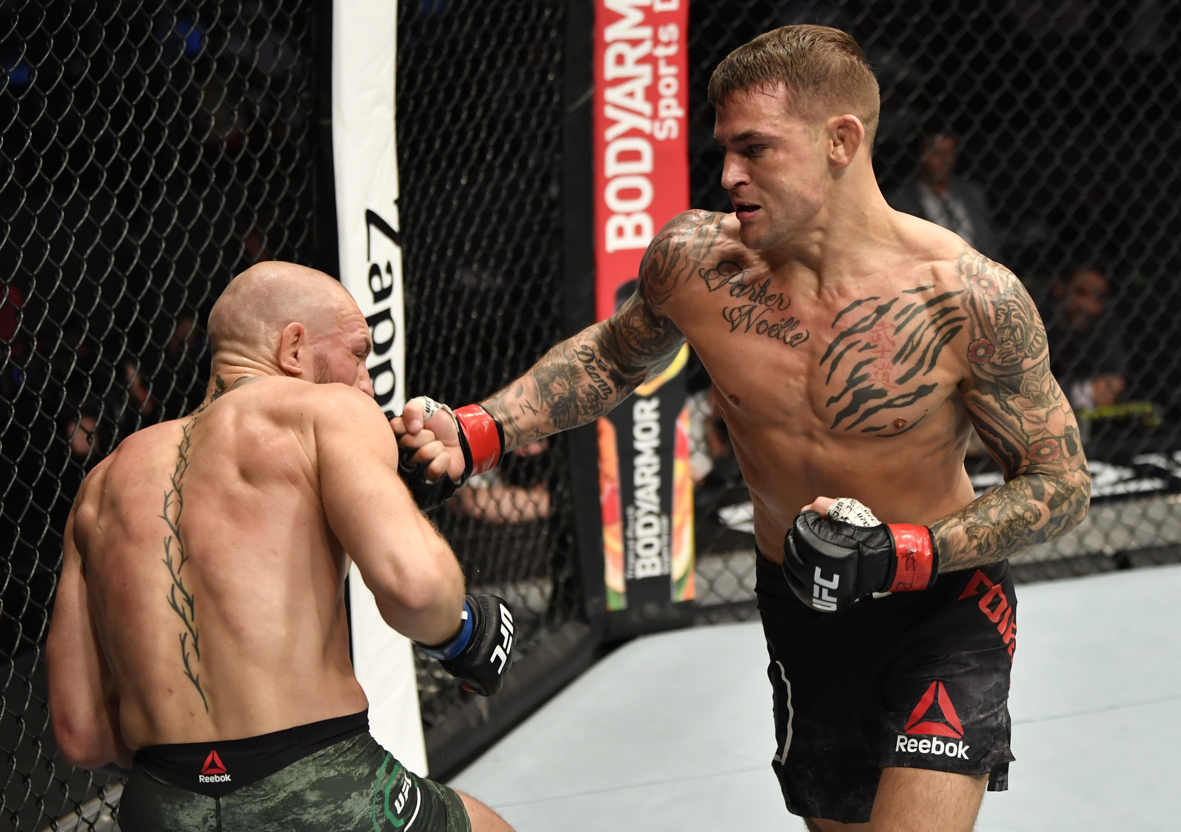 Dustin Poirier punches Conor McGregor in their lightweight main event at UFC 257. Photo: Jeff Bottari/Zuffa LLC