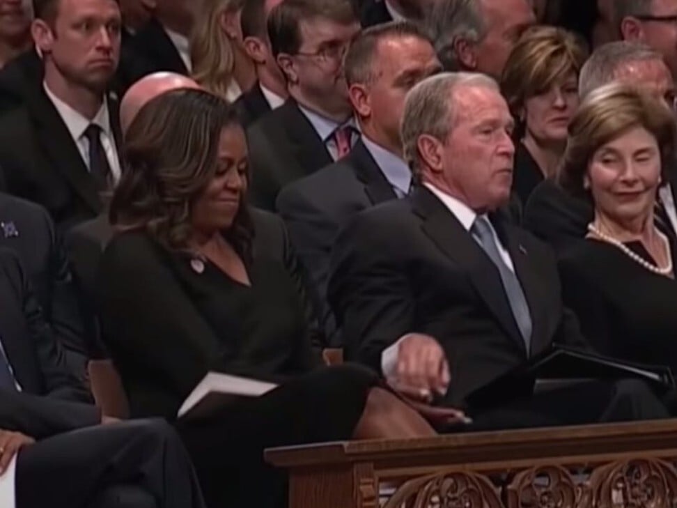 Bush hands Obama a cough drop at John McCain’s memorial. Photo: YouTube