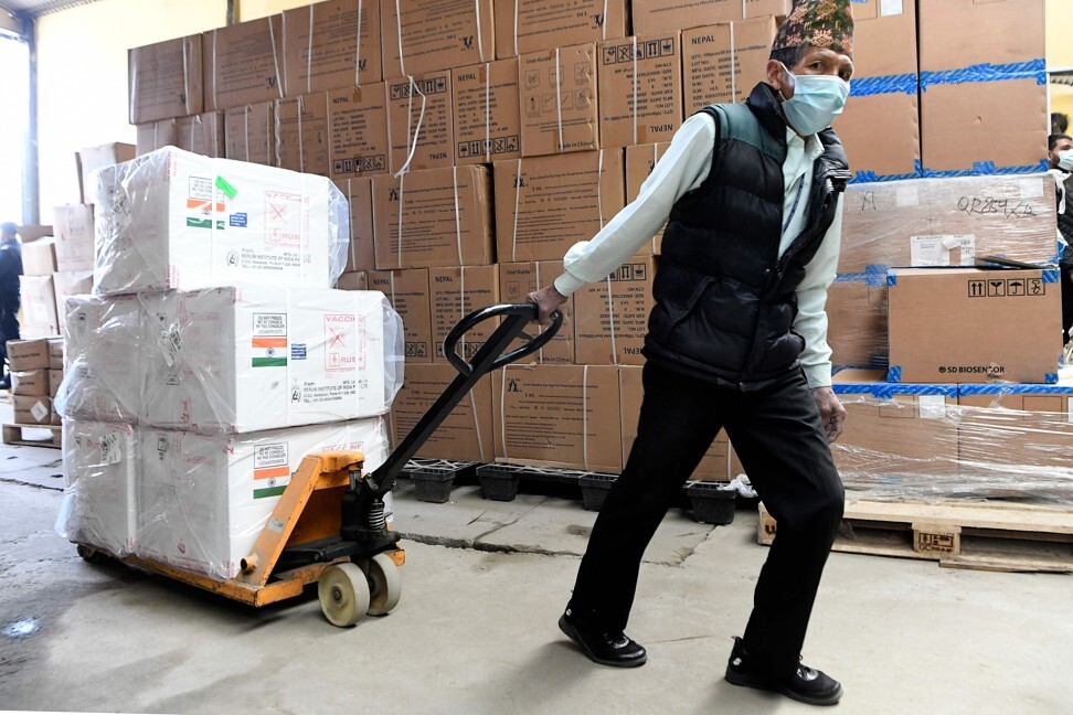 A worker unloads boxes containing Covid-19 coronavirus vaccine manufactured in India, after they arrived in Kathmandu. Photo: AFP