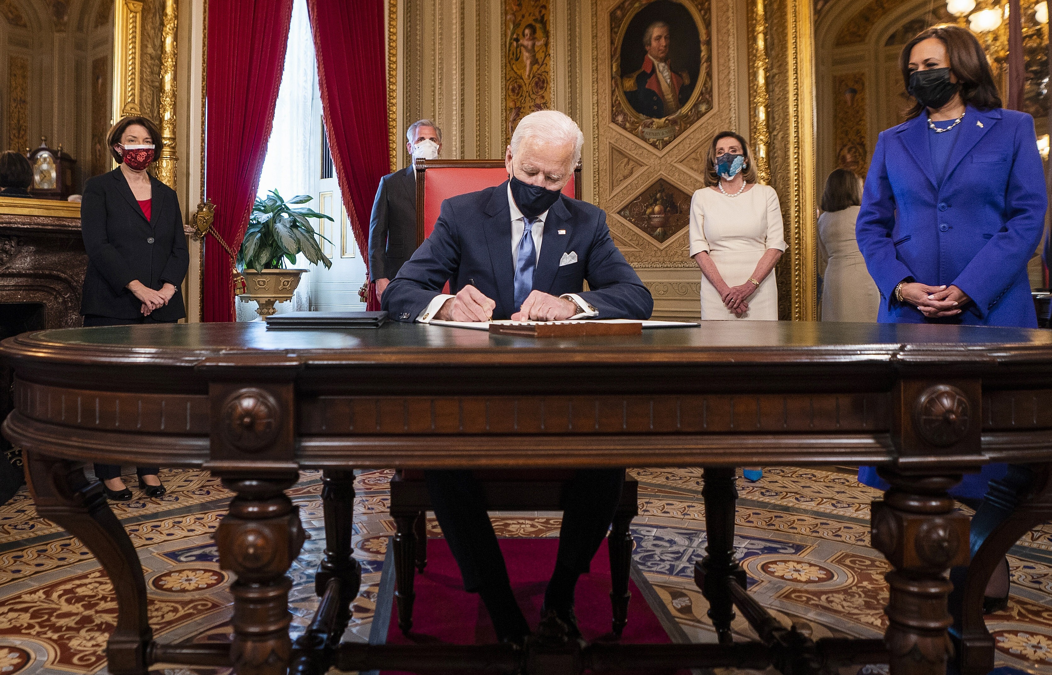 US President Joe Biden signs three documents, including cabinet nominations, in the President’s Room at the Capitol after his inauguration on January 20, as Vice-President Kamala Harris looks on. His proposed cabinet would be the most diverse in US history, if confirmed by the Senate. Photo: AP