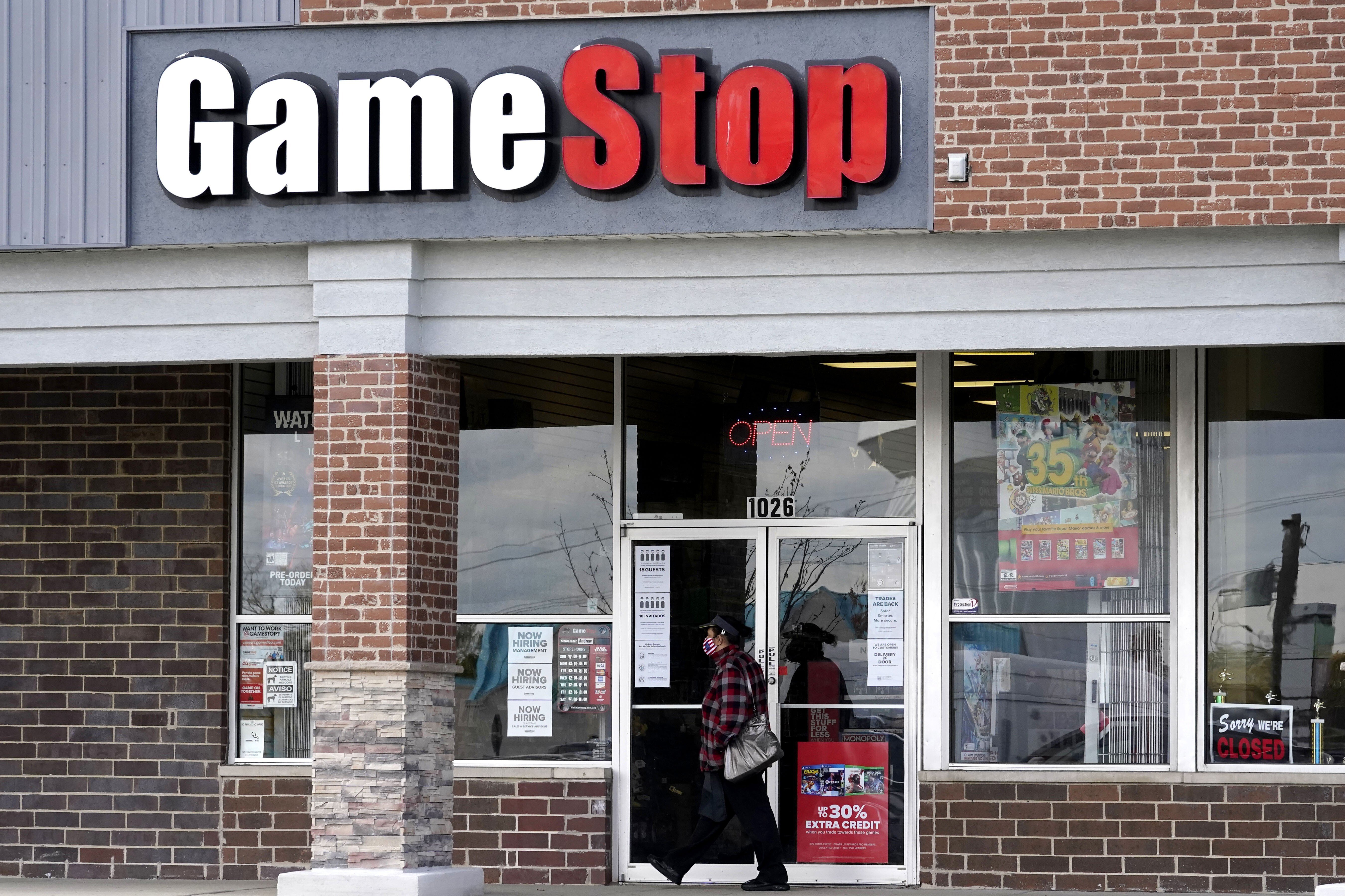 A woman walks past a GameStop store in Des Plaines, Illinois, on October 15, 2020. The money-losing video game retailer has been the focus of a trading war. Photo: AP