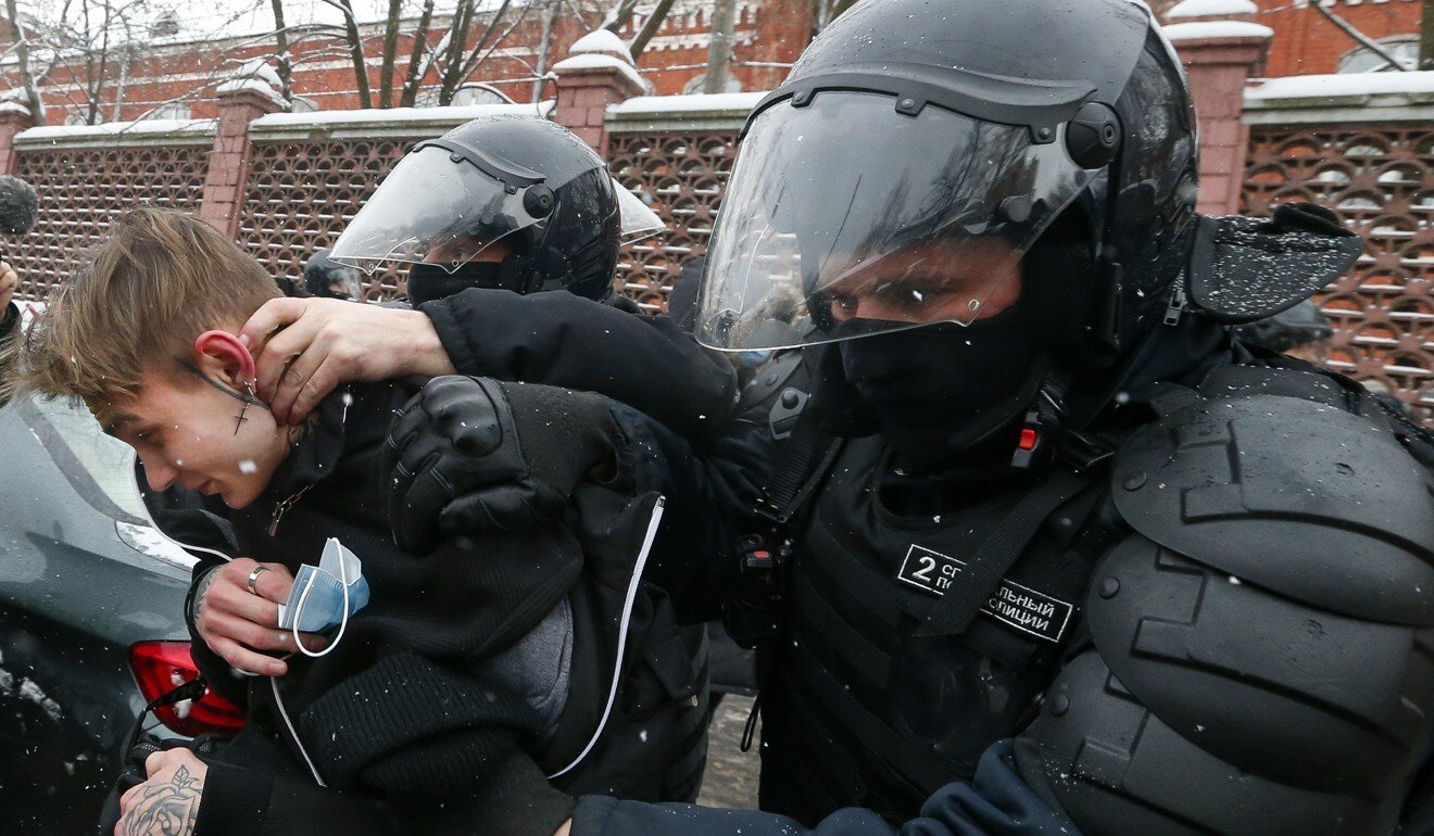 Police detain a young demonstrator in Moscow on Sunday. Photo: AP