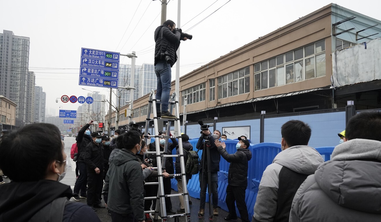 Journalists outside the Huanan Seafood Market. Photo: AP