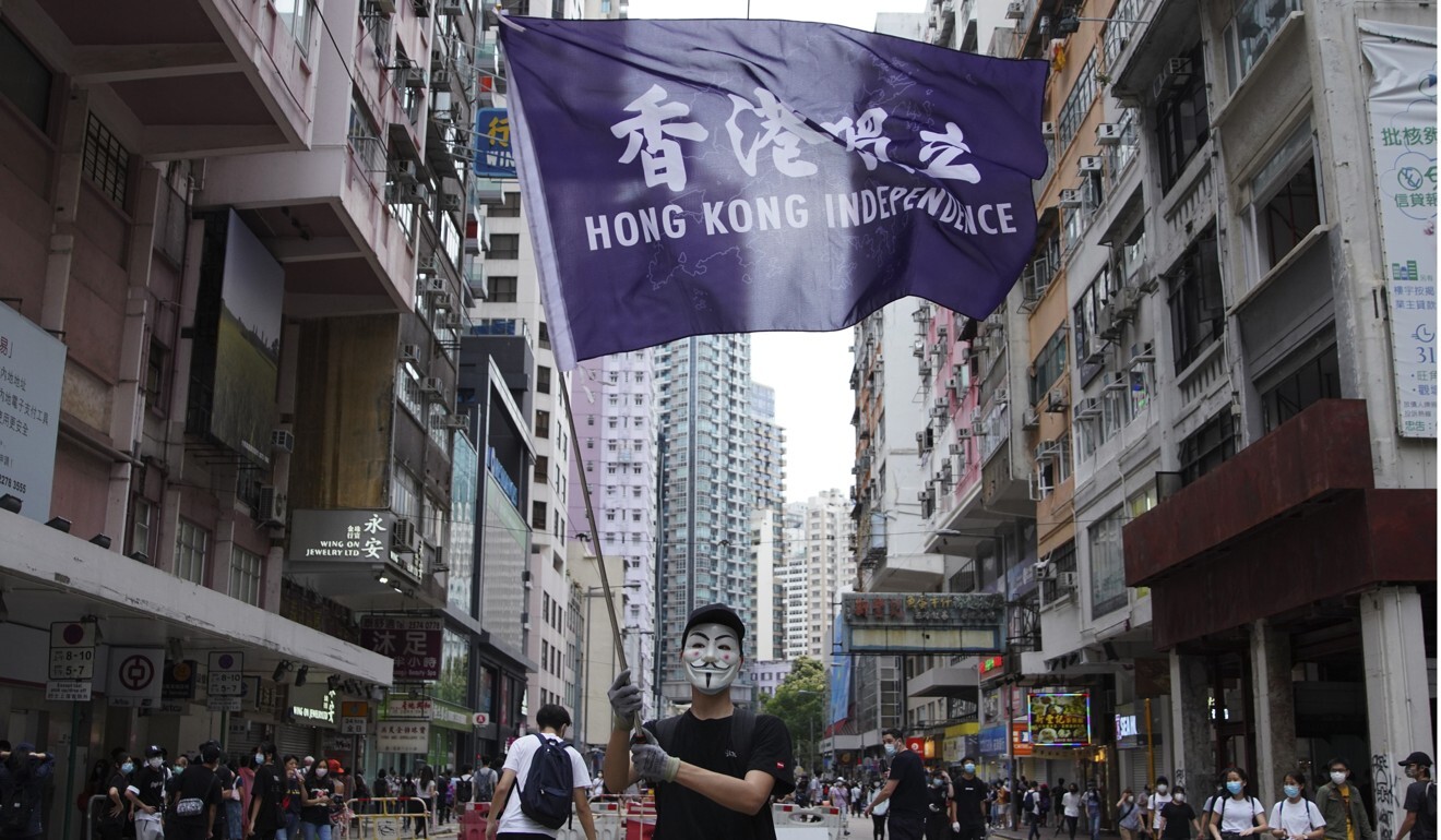 A protester wearing a Guy Fawkes mask waves a “Hong Kong Independence” flag on Johnston Road in Wan Chai during a demonstration last year. Photo: Winson Wong