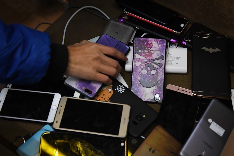 A student picks up his mobile phone after sitting an exam at a technical school in Jinan, China. From this week, students at all schools in China must hand them over during class time, and need permission to take them to school. Photo: AFP A student picks up his mobile phone after sitting an exam at a technical school in Jinan, China. From this week, students at all schools in China must hand them over during class time, and need permission to take them to school. Photo: AFP