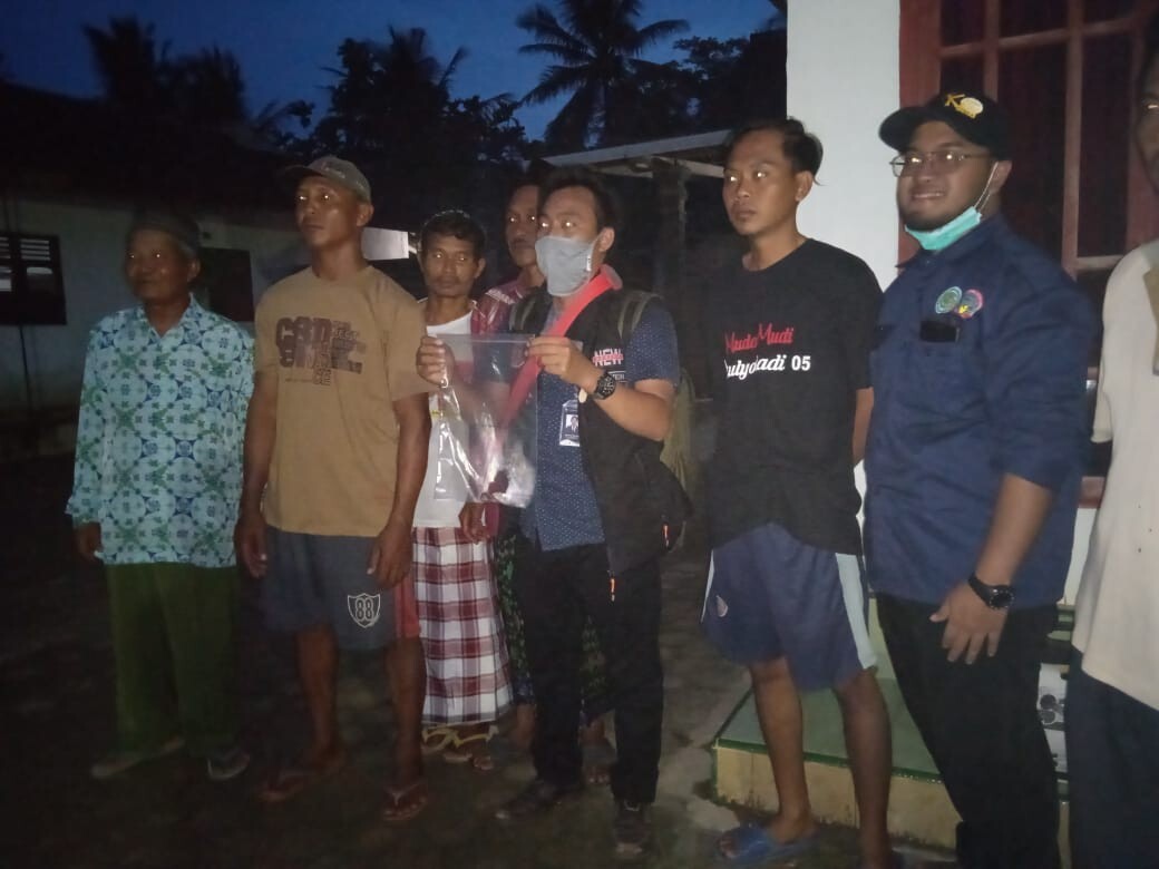 Some of the villagers from Astomulyo, with the one in the centre holding a fragment of the meteorite in a plastic bag. Photo: ITERA Lampung