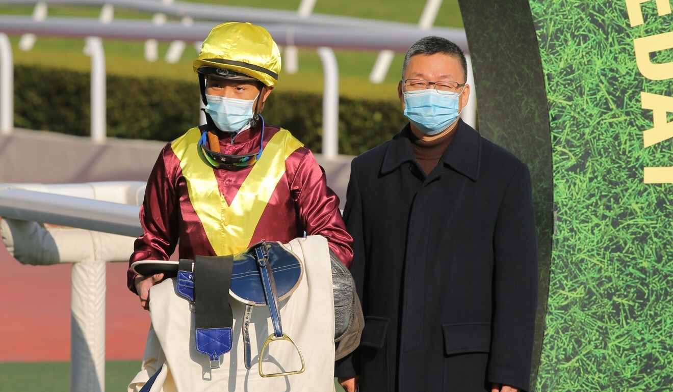 Jockey Vincent Ho and trainer Francis Lui celebrate a Sea Of Life victory.