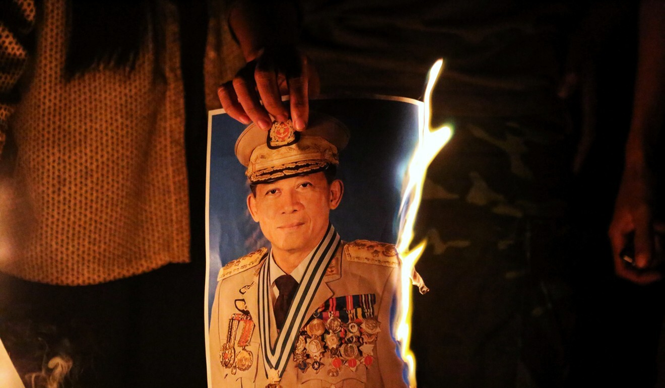 People in Myanmar burn a portrait of Army chief General Min Aung Hlaing as they protest against the military coup. Photo: Reuters