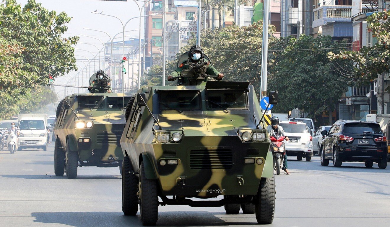Myanmar Army vehicles drive through a street following a coup. Photo: Reuters