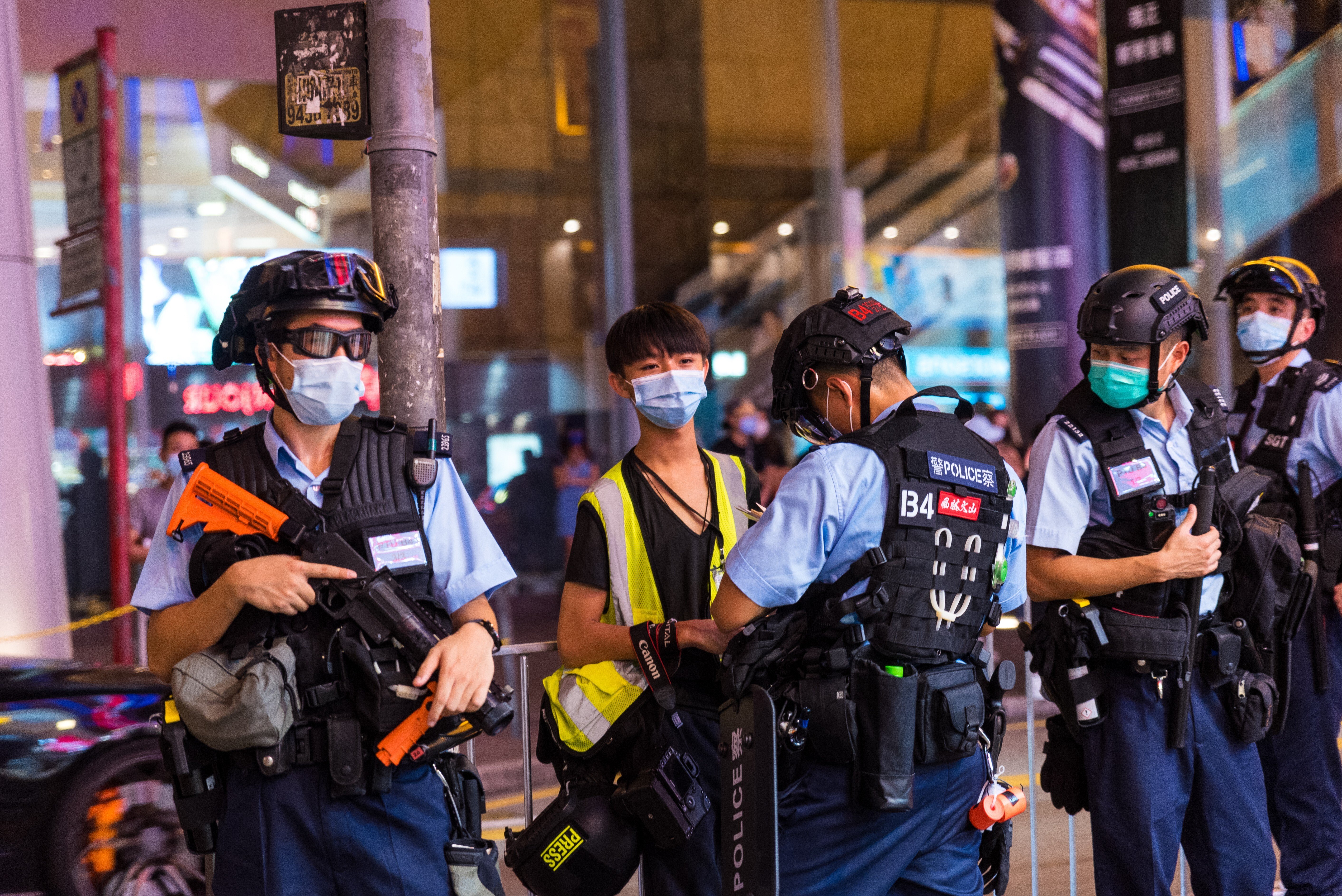 A police officer carries out a stop-and-search on a student journalist in Mong Kok on August 11, 2020. Photo: NurPhoto via Getty Images