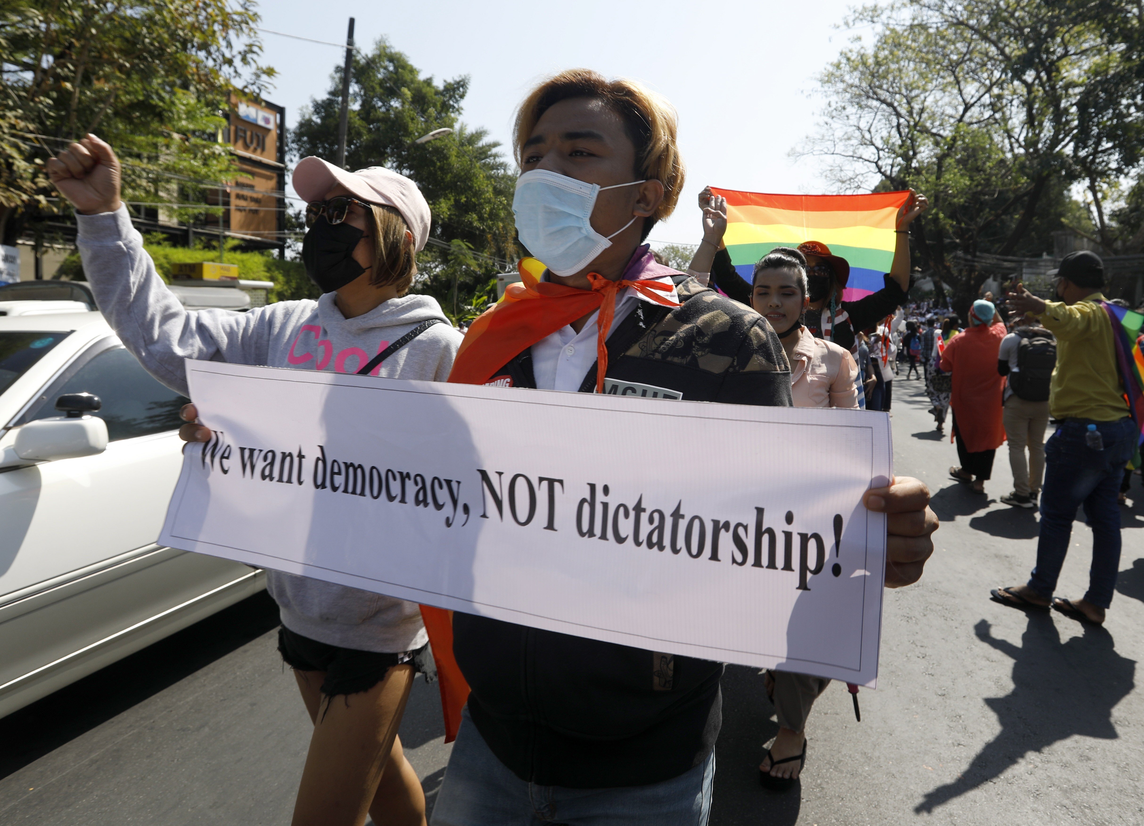Protesters hold placards and shout slogans as they march in front of the US embassy during a demonstration against the military coup, in Yangon, Myanmar, on February 10. People have continued to rally across the country despite orders banning mass gatherings and reports of increasing use of force by police against anti-coup protesters. Photo: EPA-EFE