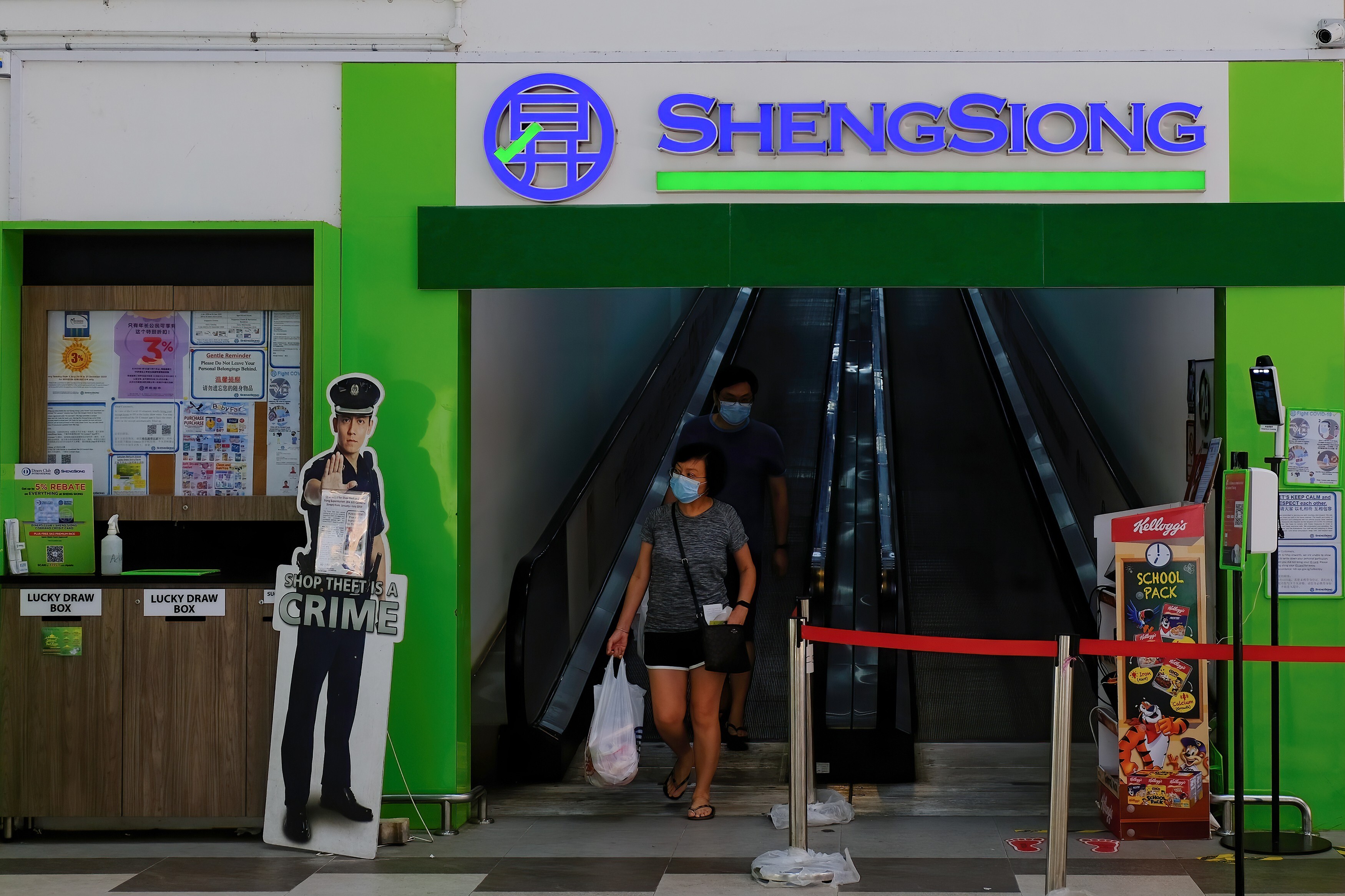 Shoppers leave a Sheng Siong supermarket at Canberra estate in Singapore. Most of the company’s 64 stores are found in public housing blocks with a high concentration of flats. Photo: Shutterstock