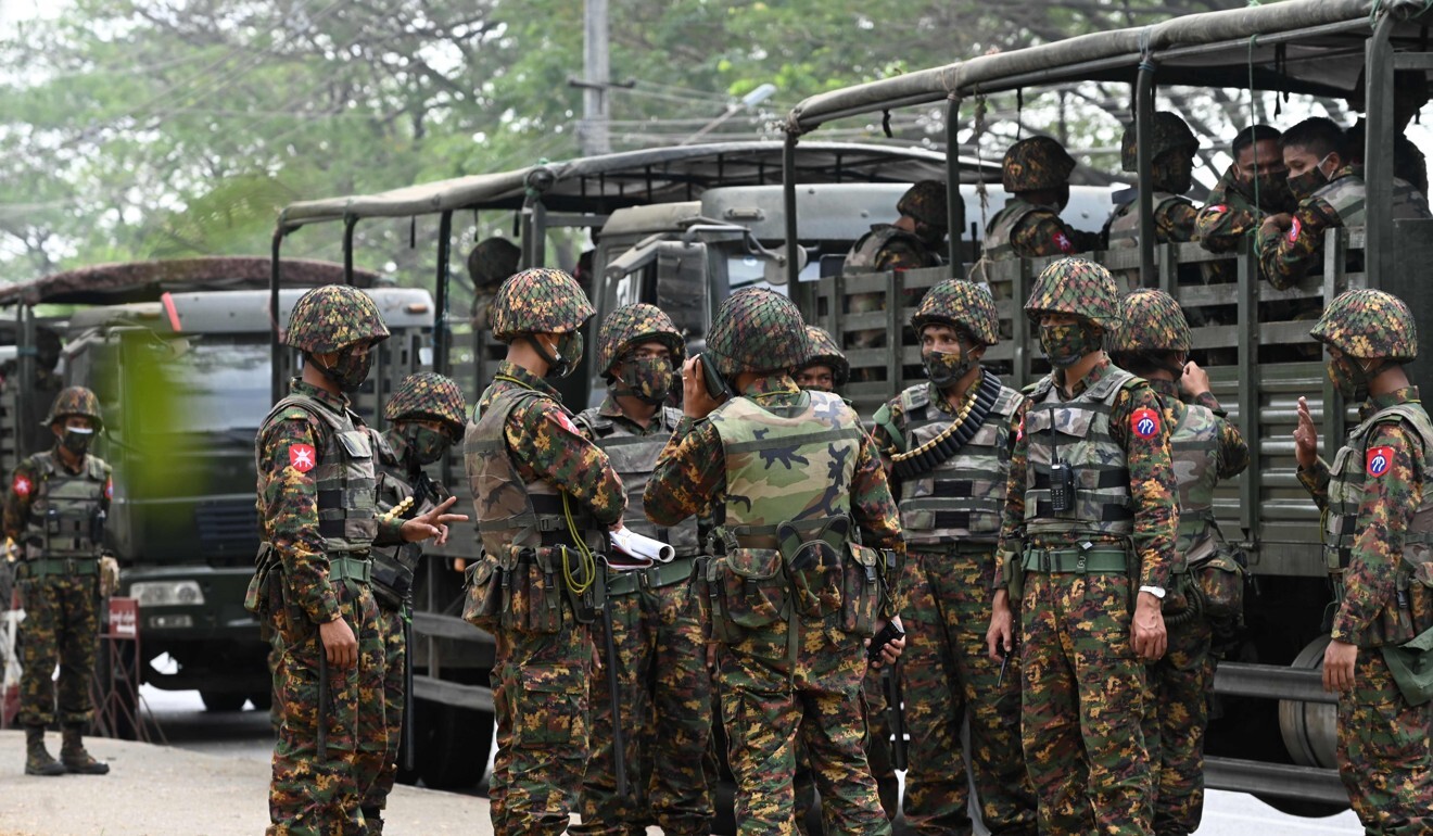 Soldiers stand outside the Central Bank of Myanmar as people gathered in protest on February 15. Photo: AFP