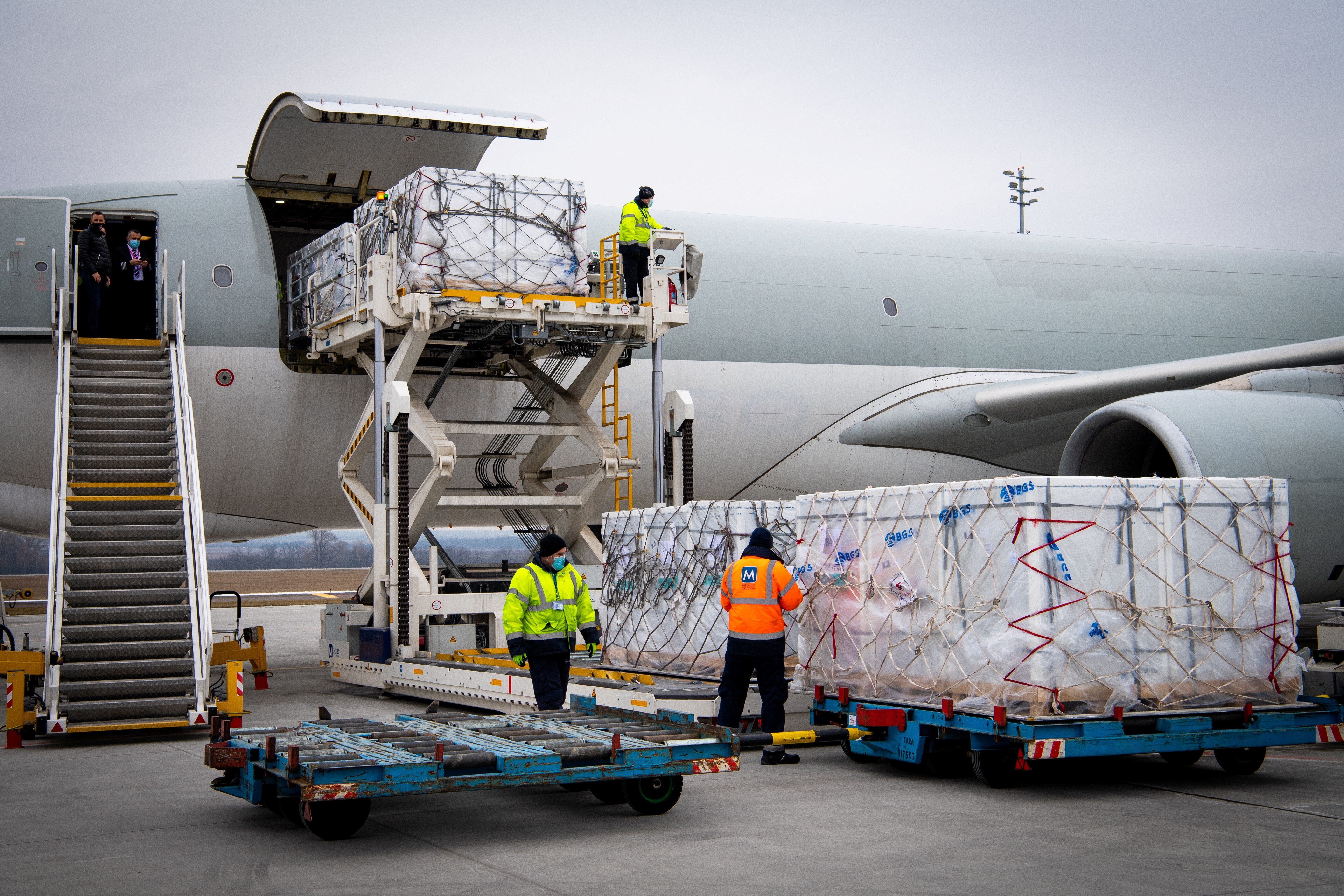 Workers unload a shipment of China’s Sinopharm Covid-19 vaccine as it arrives at Budapest Airport on February 16. Photo: Handout via Reuters