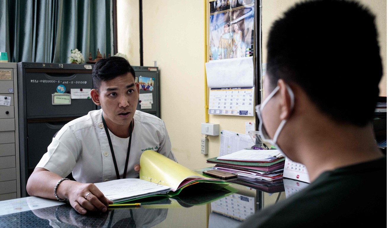 Rehabilitation psychologist Shaowpicha Techo (L) speaks with a former meth user during a check-up at Bangkok Health Centre's Khlong Toei clinic. Photo: AFP