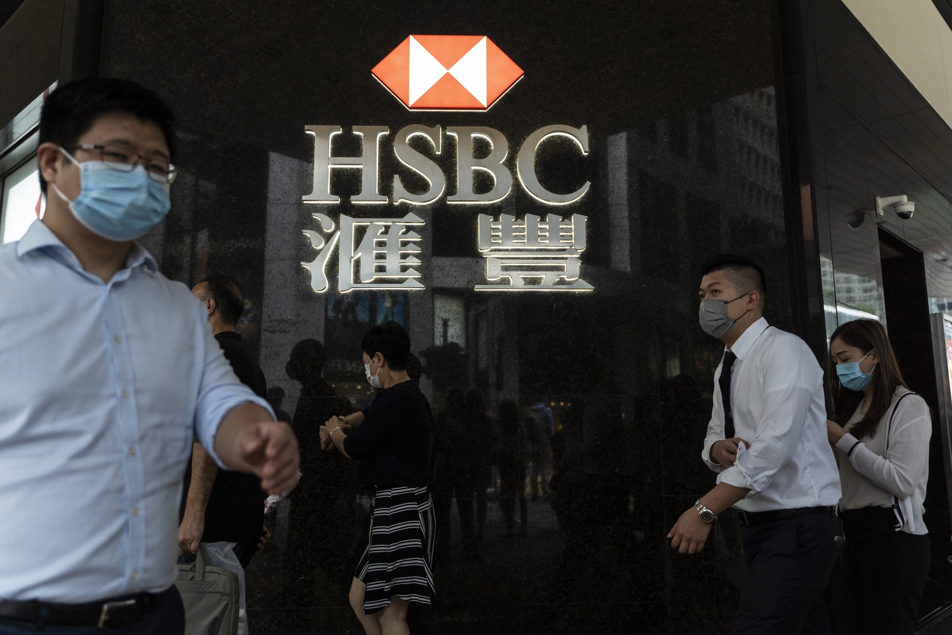 Pedestrians pass an HSBC bank branch in Hong Kong on September 21, 2020. HSBC has warned it might have to set aside up to US$13 billion to cover non-performing loans. Photo: Bloomberg