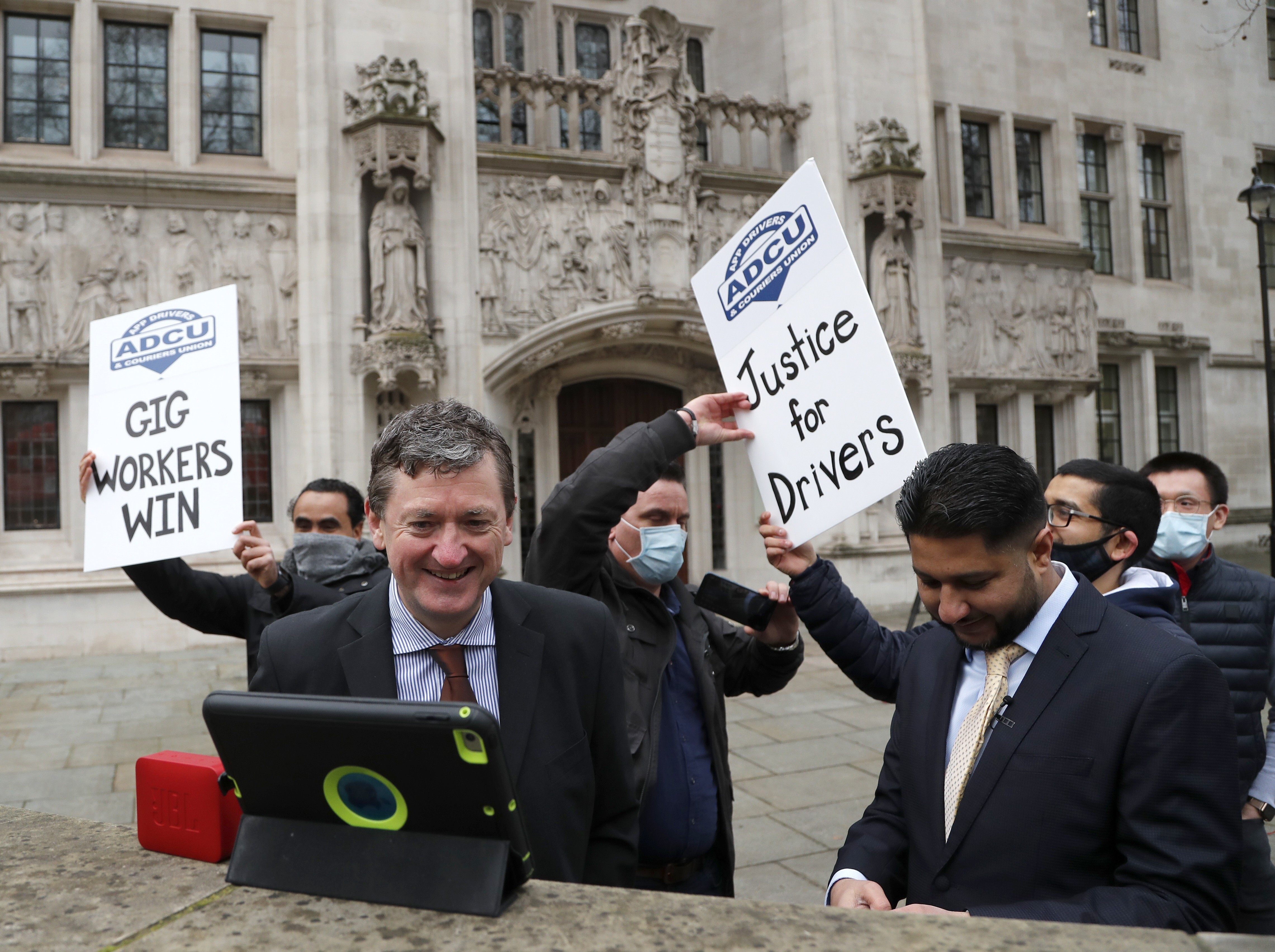 Uber drivers celebrate outside the Supreme Court in London on Friday. Photo: AP