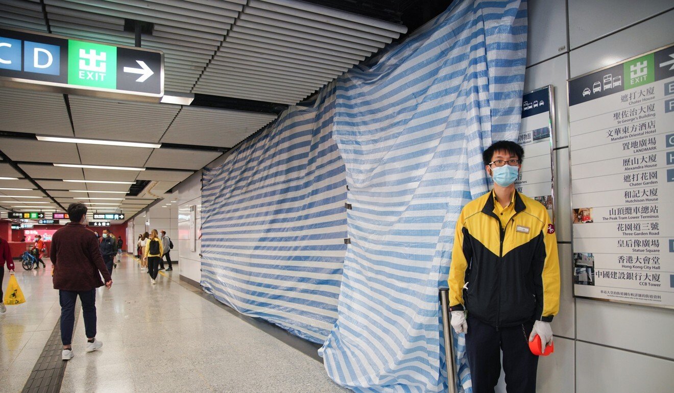 An MTR employee stands near an area that has been cordoned off after a false ceiling collapsed in Central MTR station on Saturday evening. Photo: Winson Wong