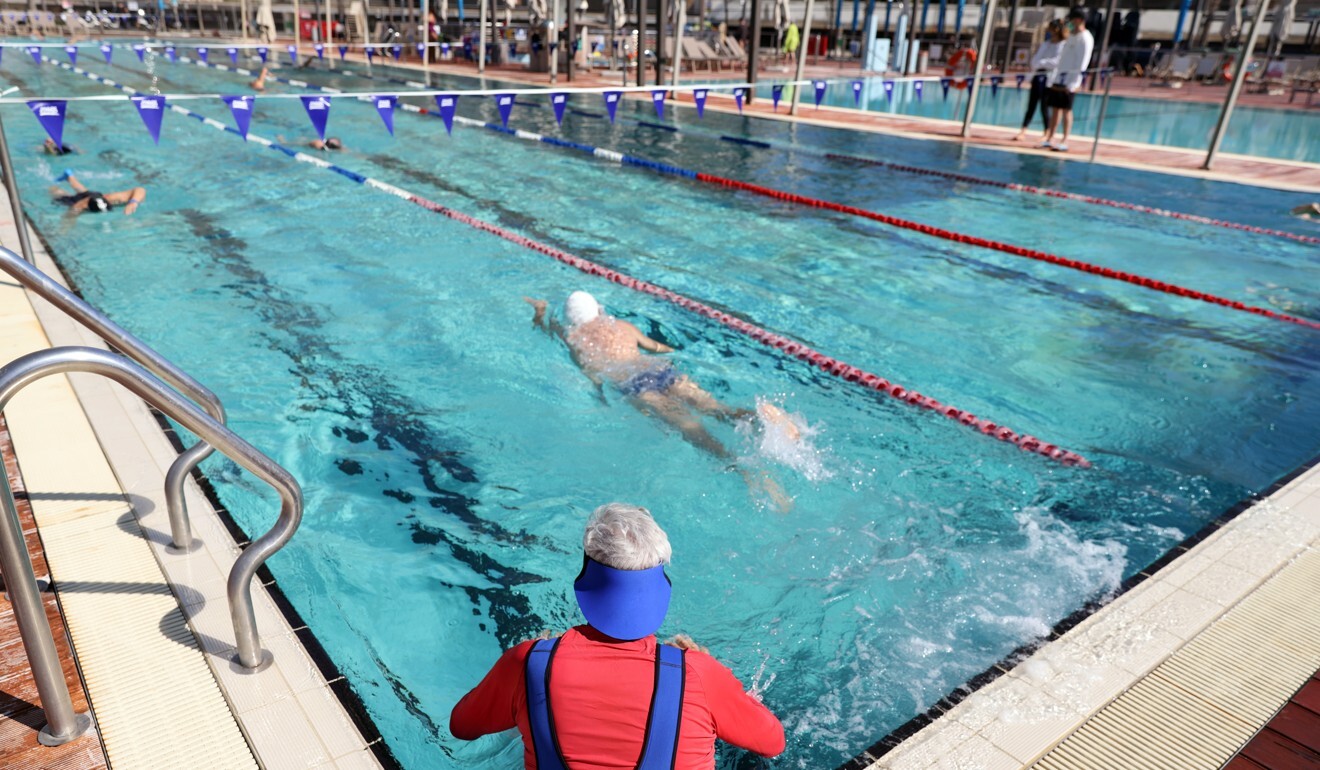 People swim at a pool in Tel Aviv where a ‘green pass’ is required to enter. Photo: Reuters