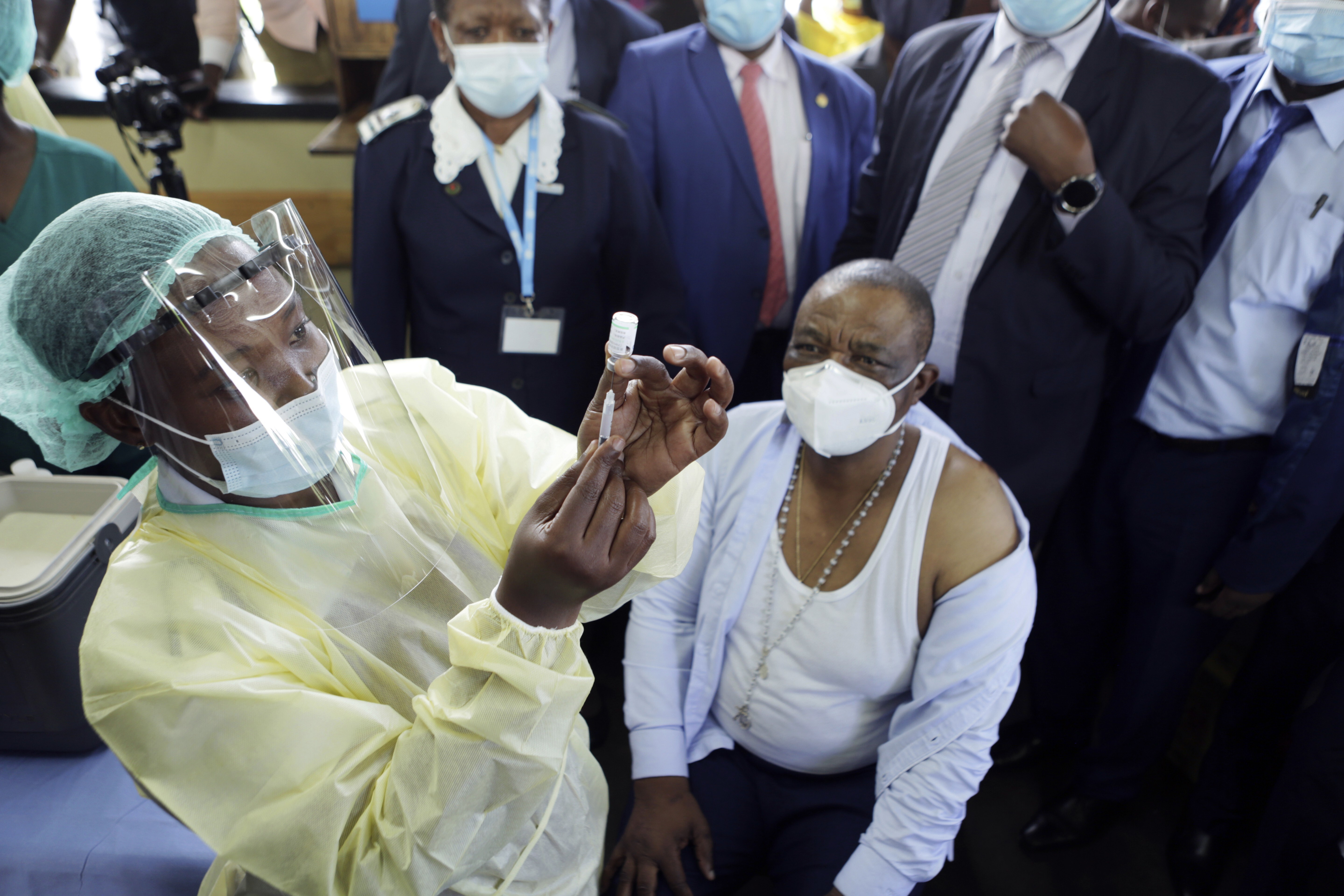 A nurse prepares to give a shot of the Sinopharm Covid-19 vaccine to Zimbabwean vice-president Constantino Chiwenga at a hospital in Harare on February 18, after Zimbabwe received 200,000 doses of the vaccine donated by China. Photo: AP