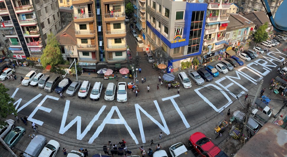 Protesters write a pro-democracy on a Yangon street on February 21. Photo: Reuters
