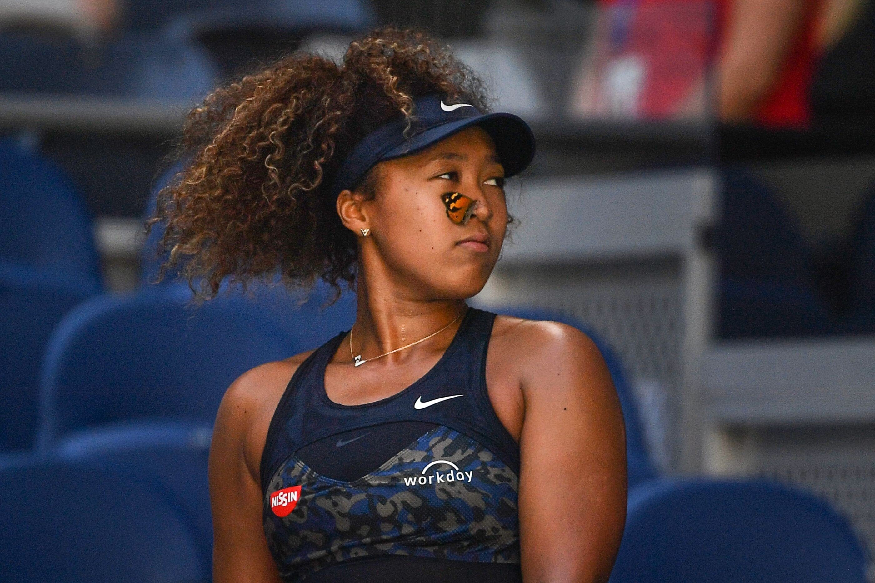A butterfly lands on Naomi Osaka’s face before she gently carries it to safety during her march to the Australian Open title. Photo: AFP