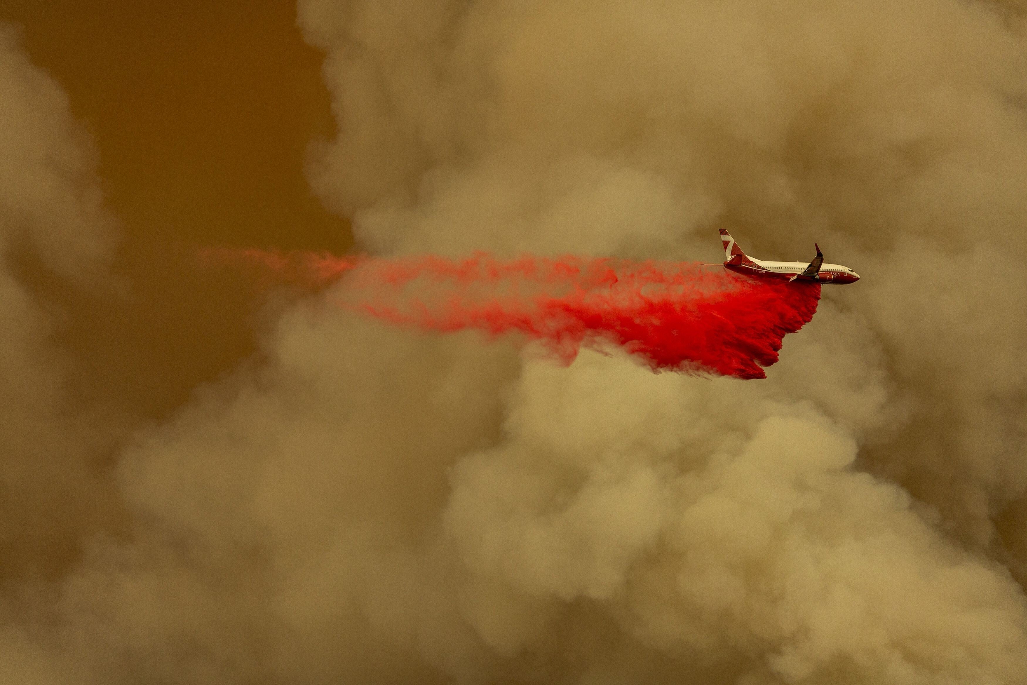 A firefighting tanker jet drops retardant to slow a blaze at the top of a mountainside in the Angeles National Forest on September 10, 2020. Climate change has played a role in the wildfires that have ravaged California in recent years. Photo: Getty Images/AFP
