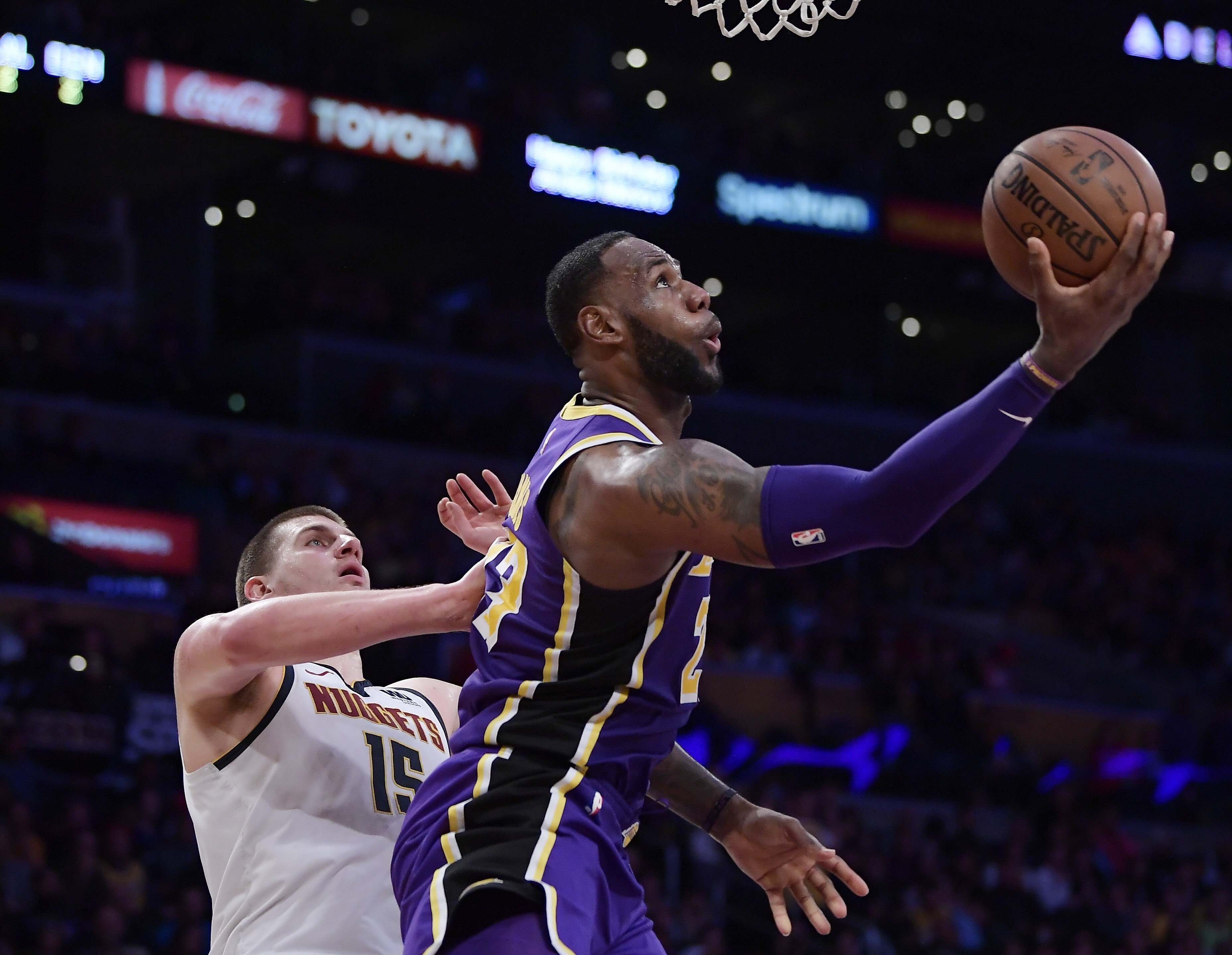 Los Angeles Lakers forward LeBron James, shoots as Denver Nuggets centre Nikola Jokic watches on. The pair will play in the NBA All-Star game. Photo: AP