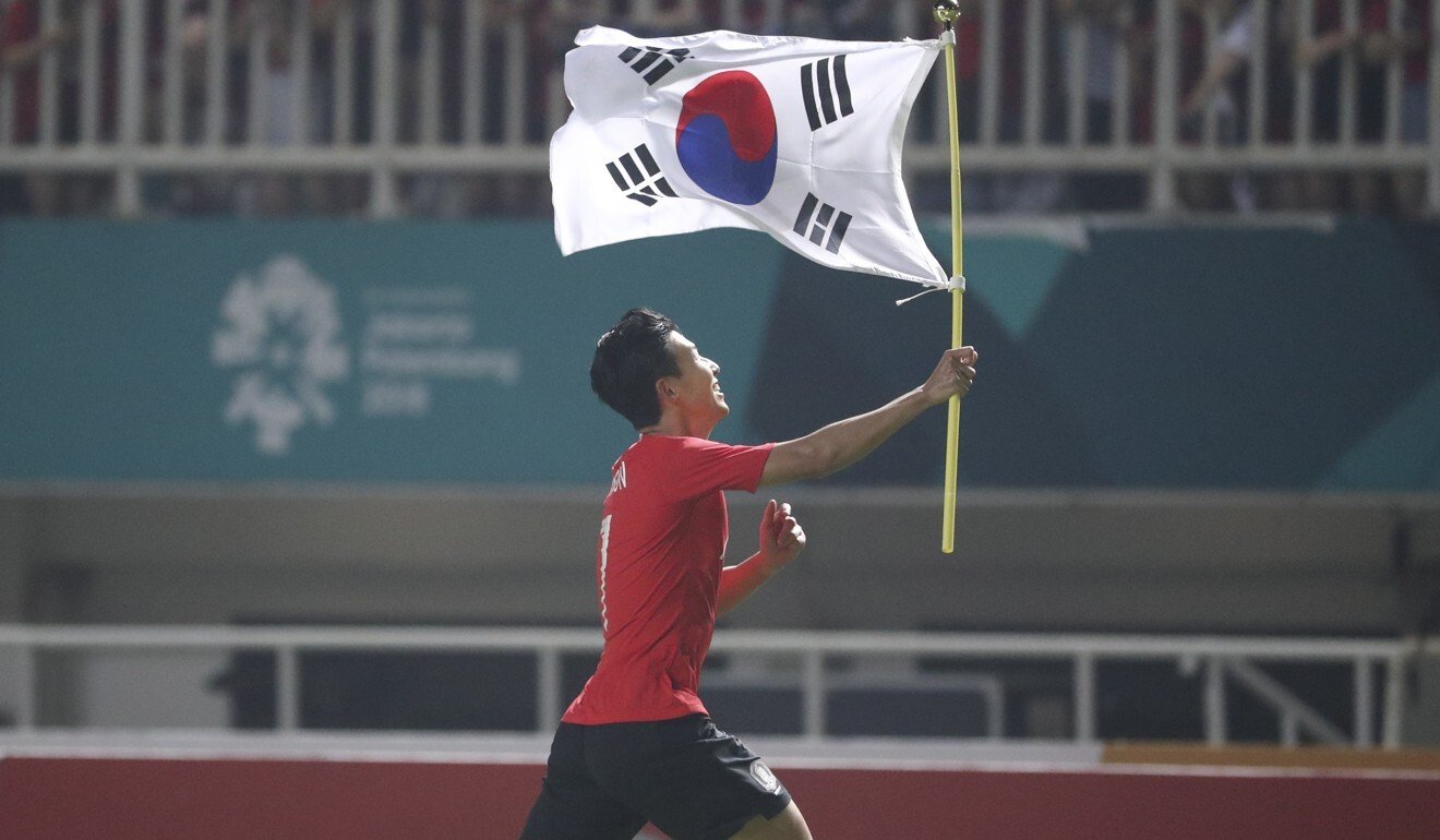 South Korea's Son Heung Min waving the national flag after winning a team gold medal at the Asian Games in Indonesia in 2018. Photo: EPA