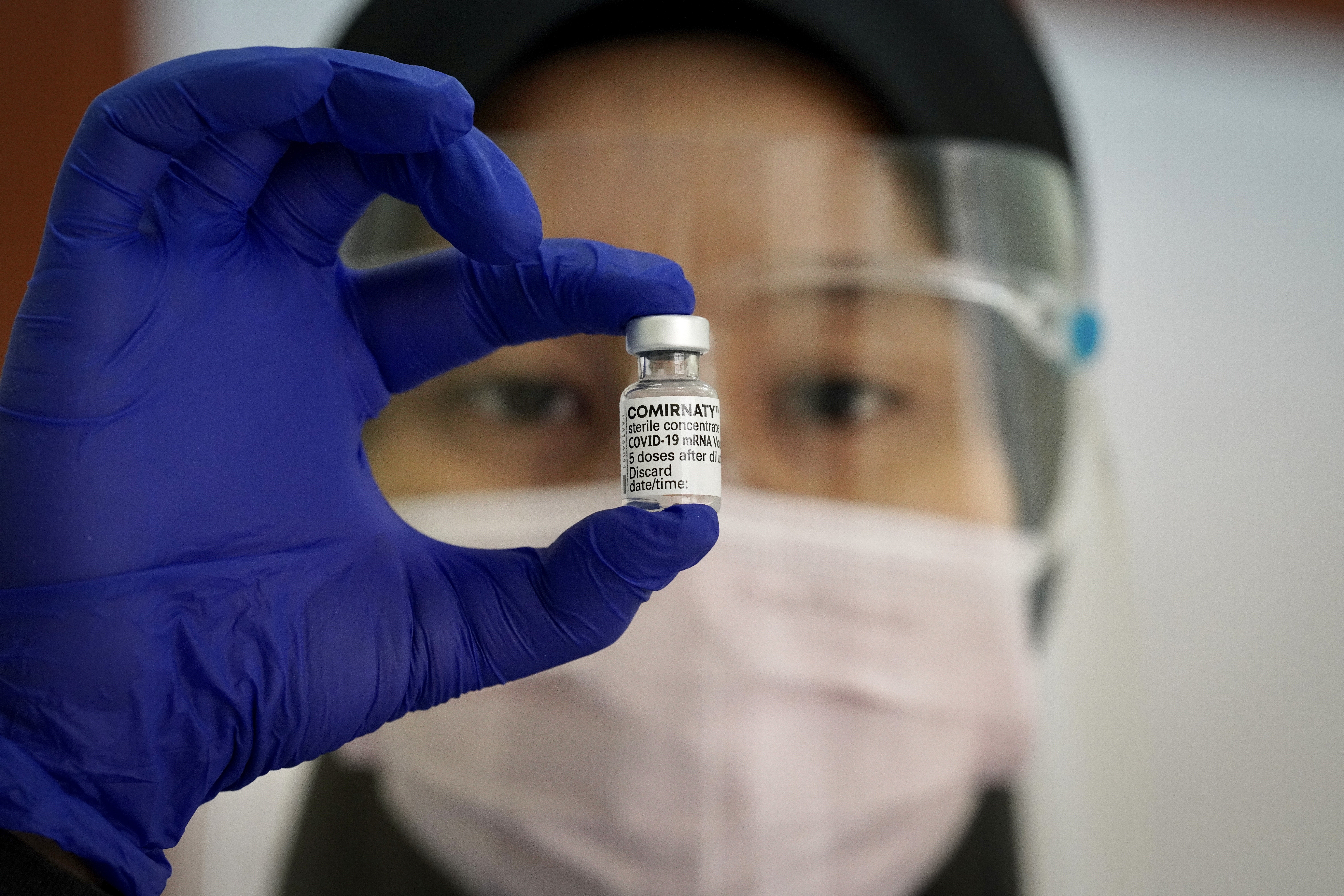 A health worker holds a vial of Pfizer’s Covid-19 vaccine to be administered to staff at a hospital in Sungai Buloh. Photo: AP