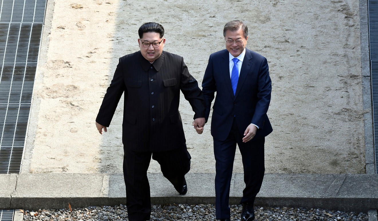North Korean leader Kim Jong-un (left) and South Korean President Moon Jae-in cross the military demarcation line at the border village of Panmunjom in 2020. Photo: AP