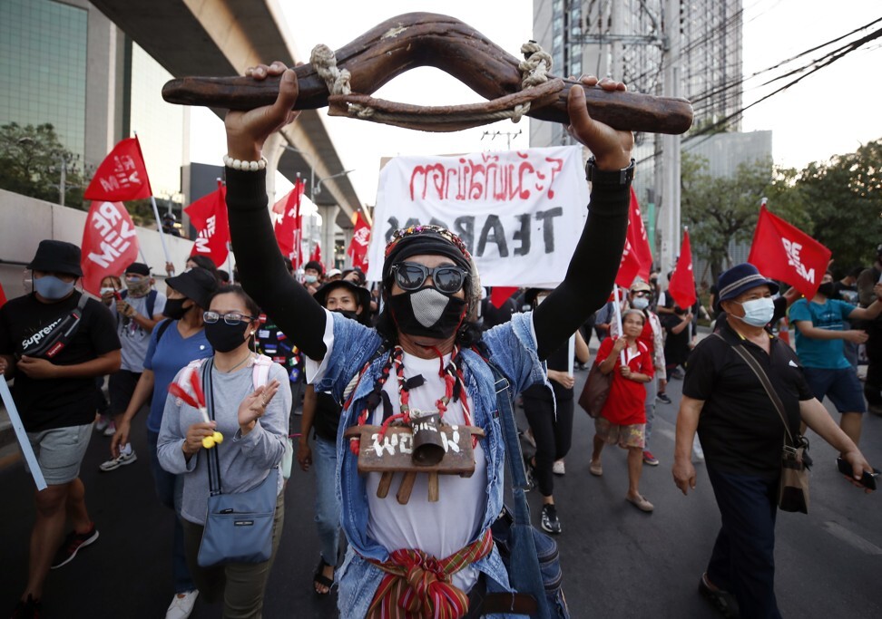 Anti-government protesters march towards the Bangkok criminal court during a rally on Saturday. Photo: EPA-EFE