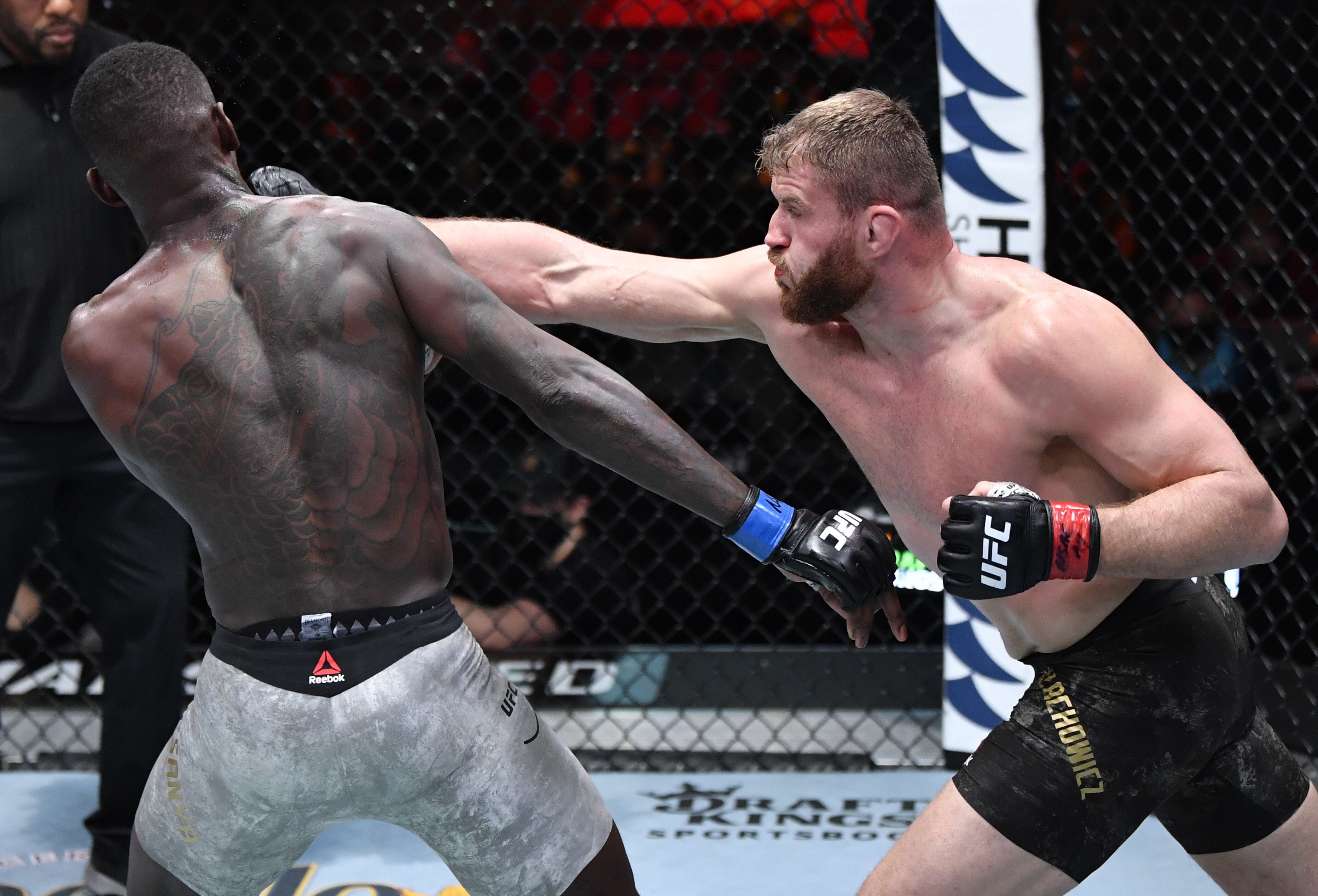 Jan Blachowicz punches Israel Adesanya in their UFC light heavyweight championship fight. Photos: Jeff Bottari/Zuffa LLC