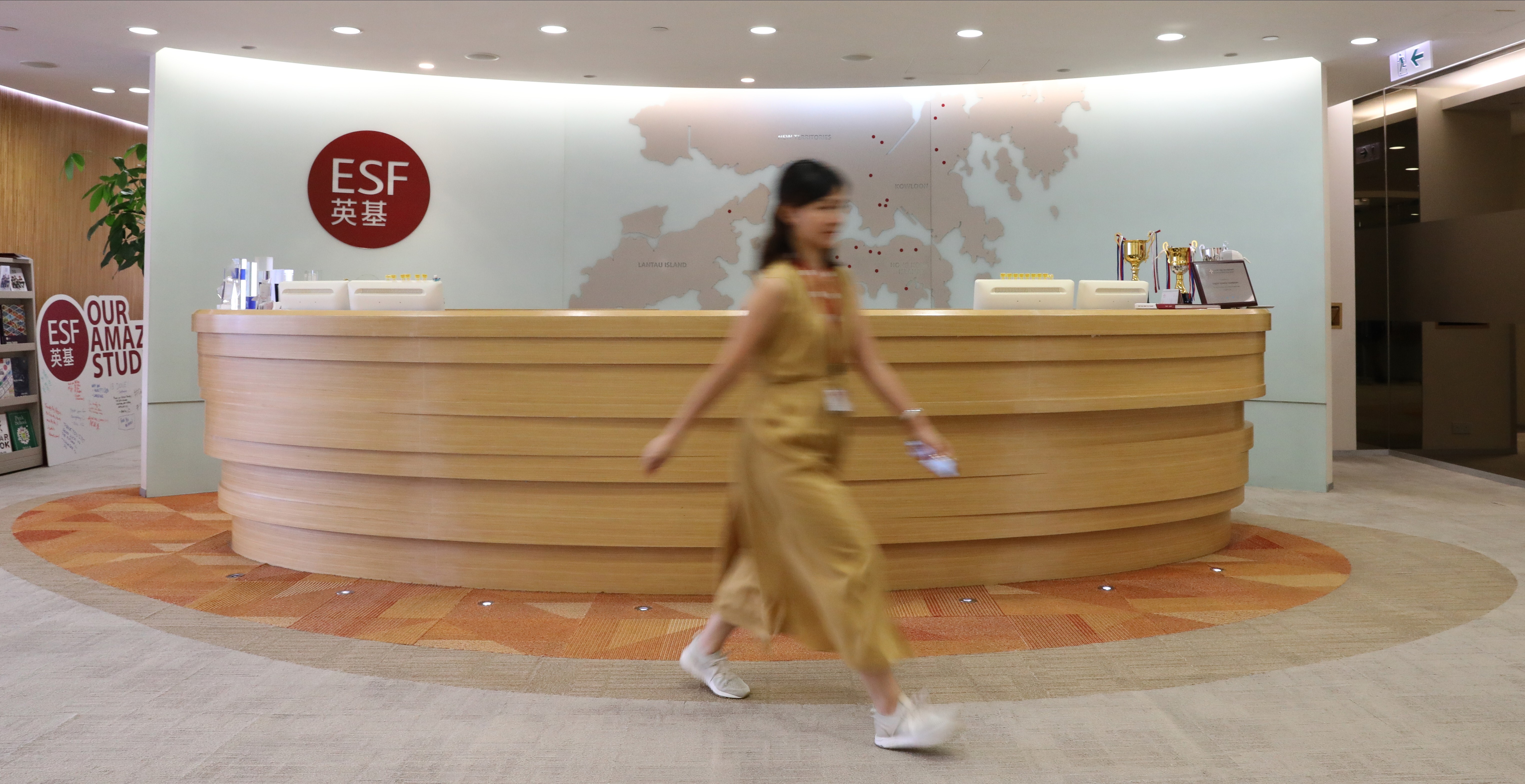 A staff member walks through the reception area of the English Schools Foundation office in Quarry Bay. Photo: May Tse