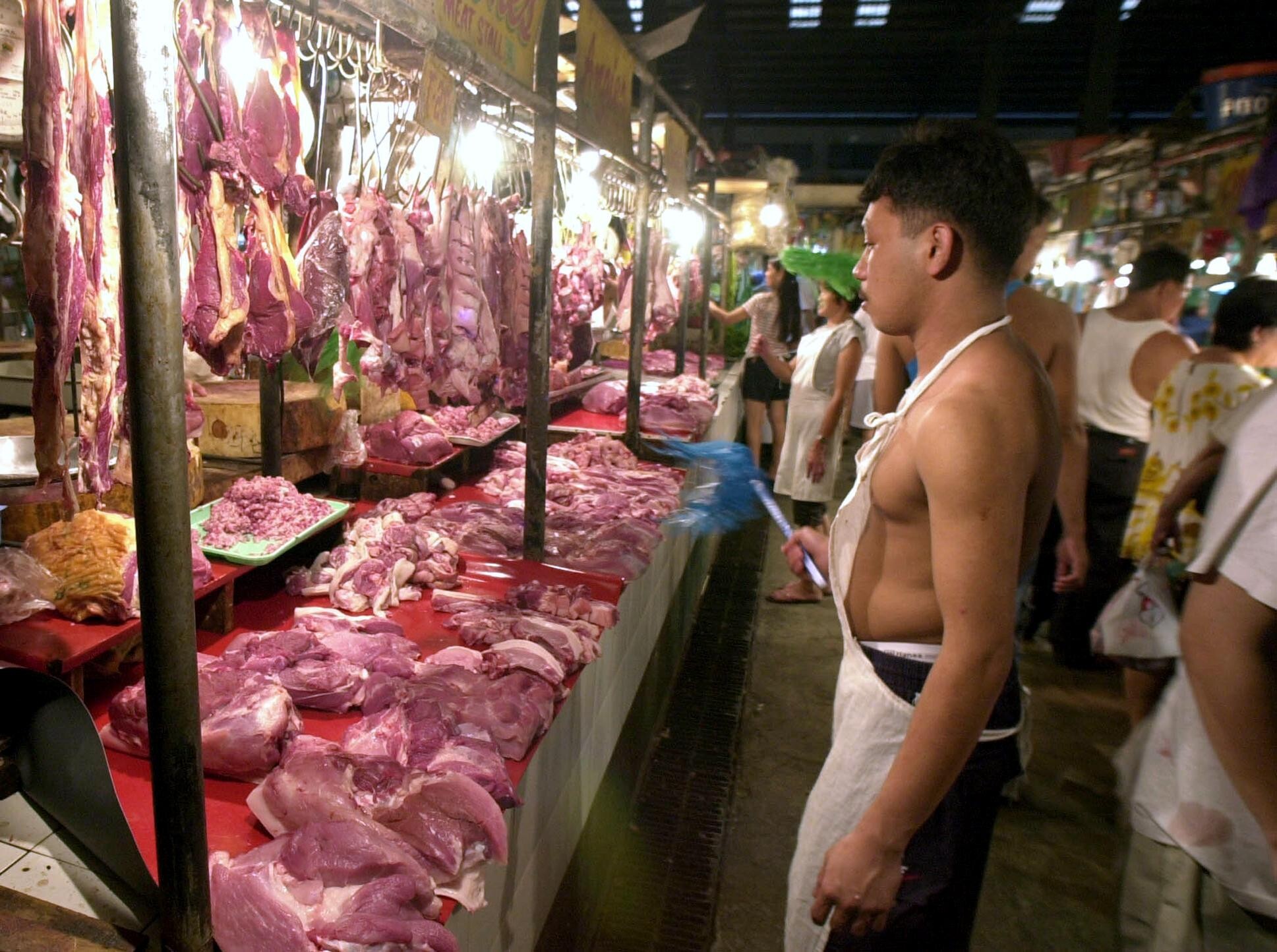 A meat seller at a market in Makati, the Philippines. Pork is a staple of the nation’s diet. Photo: AFP