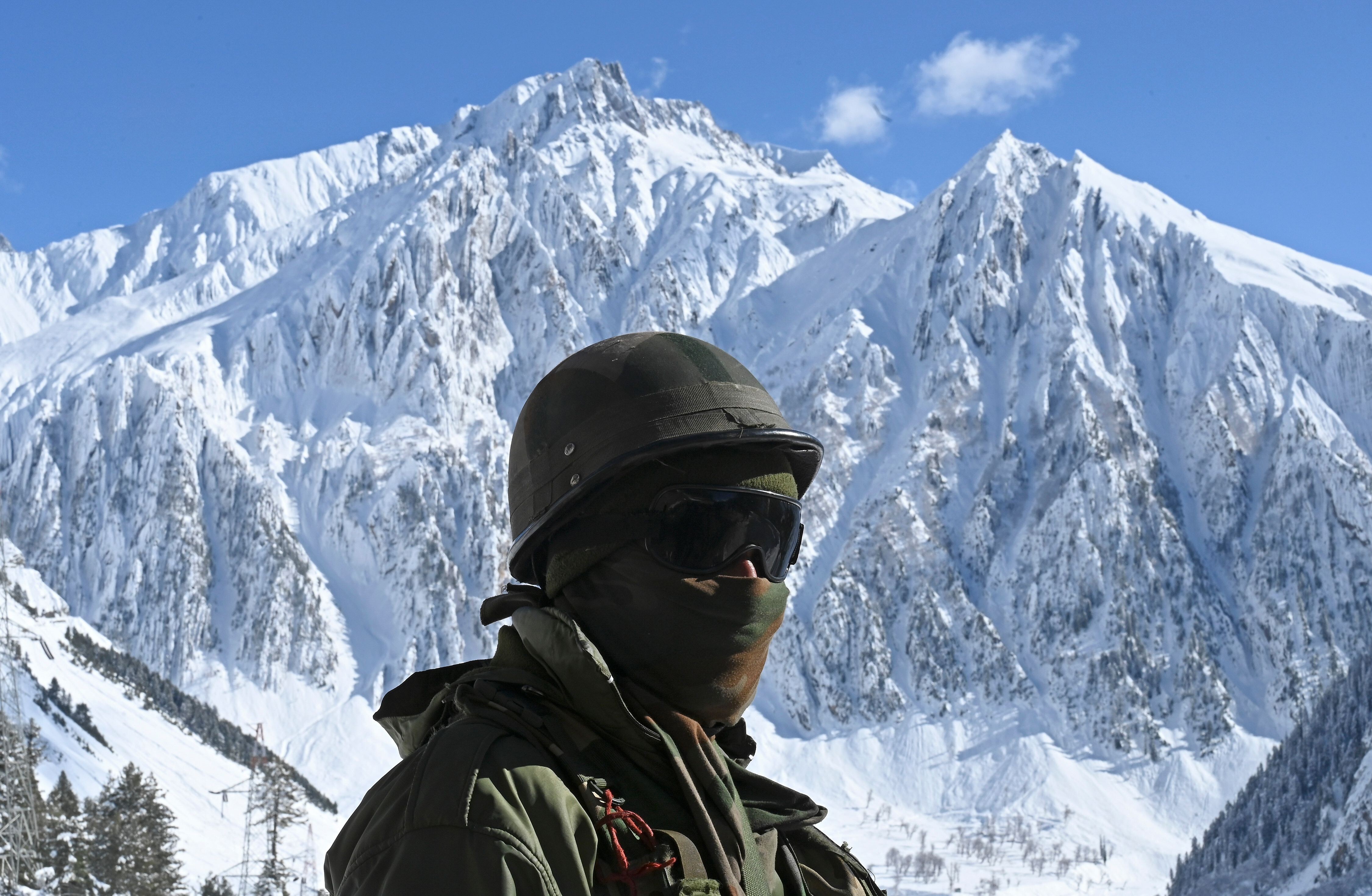 An Indian soldier stands guard near a mountain pass that connects Srinagar to Ladakh, bordering China. Photo: AFP