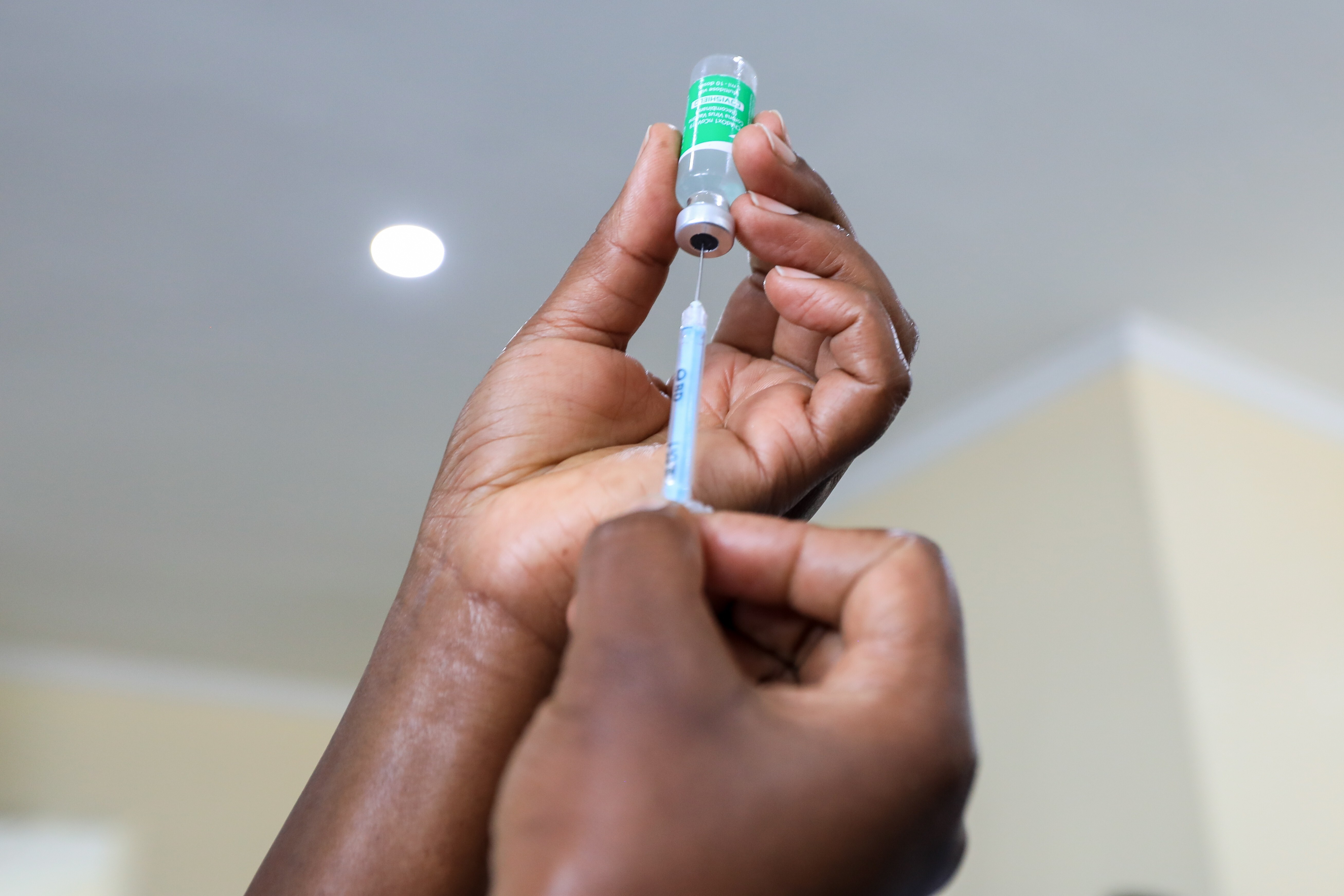 A Kenyan health care worker prepares to administer a dose of the Oxford/AstraZeneca Covid-19 vaccine. Many poorer countries are far behind Western nations in their roll-out programmes, being unable to purchase vaccines at the same scale and price. Photo: EPA-EFE