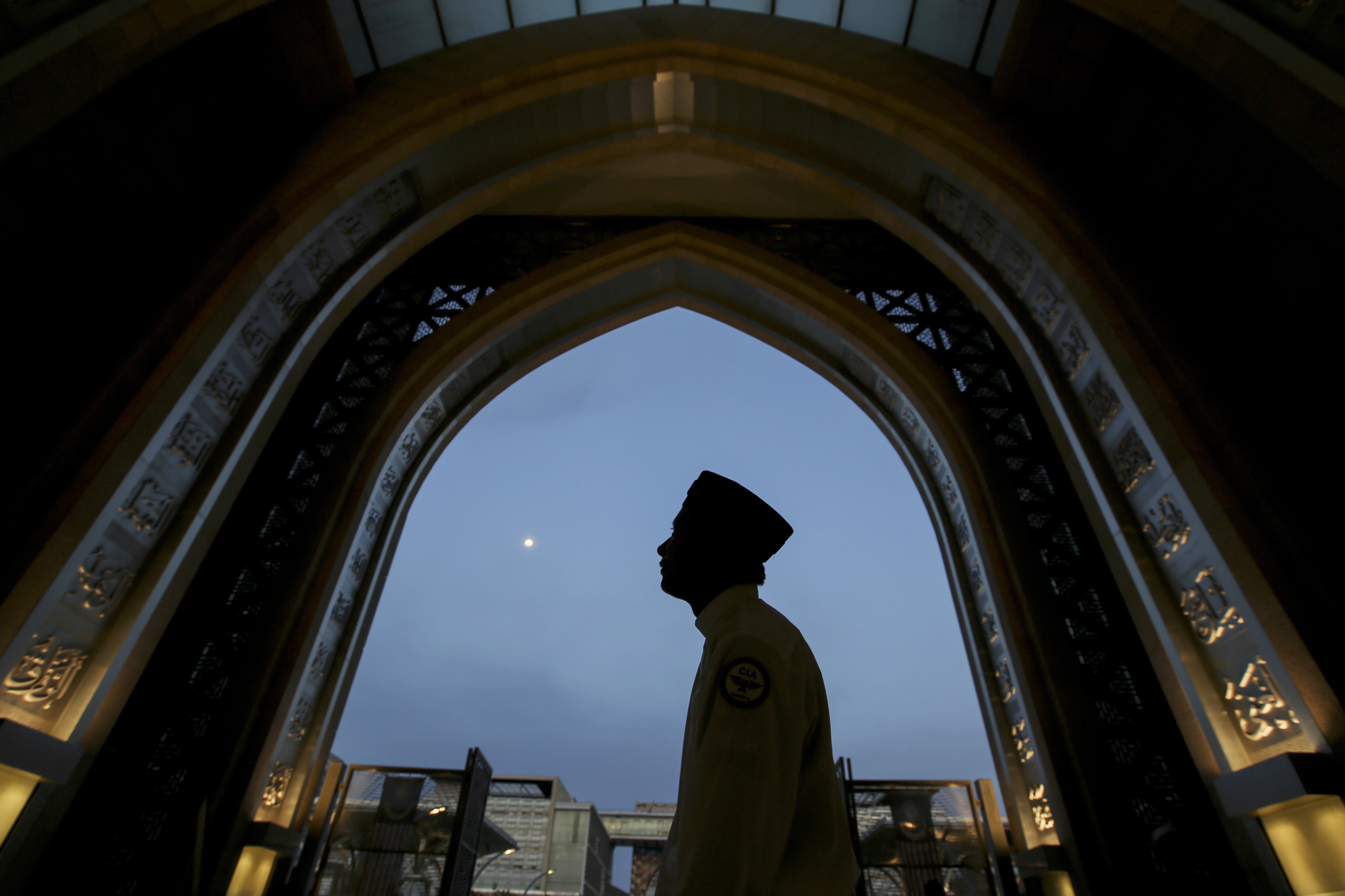 A worshipper arrives at a mosque in Kuala Lumpur during the holy Islamic month of Ramadan. Photo: AP