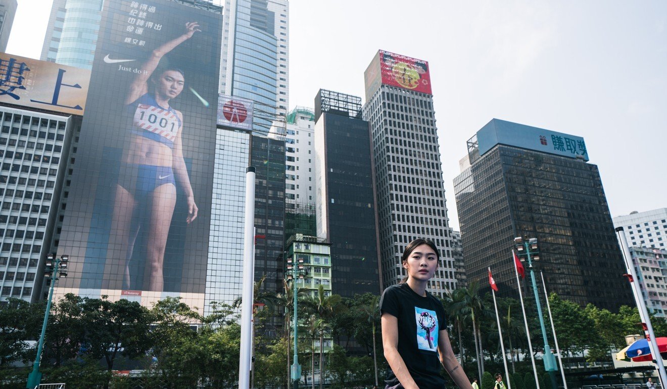 Cecelia Yeung at Wan Chai Sports Ground in front of a hoarding featuring her Nike advertisement. Photo: Handout