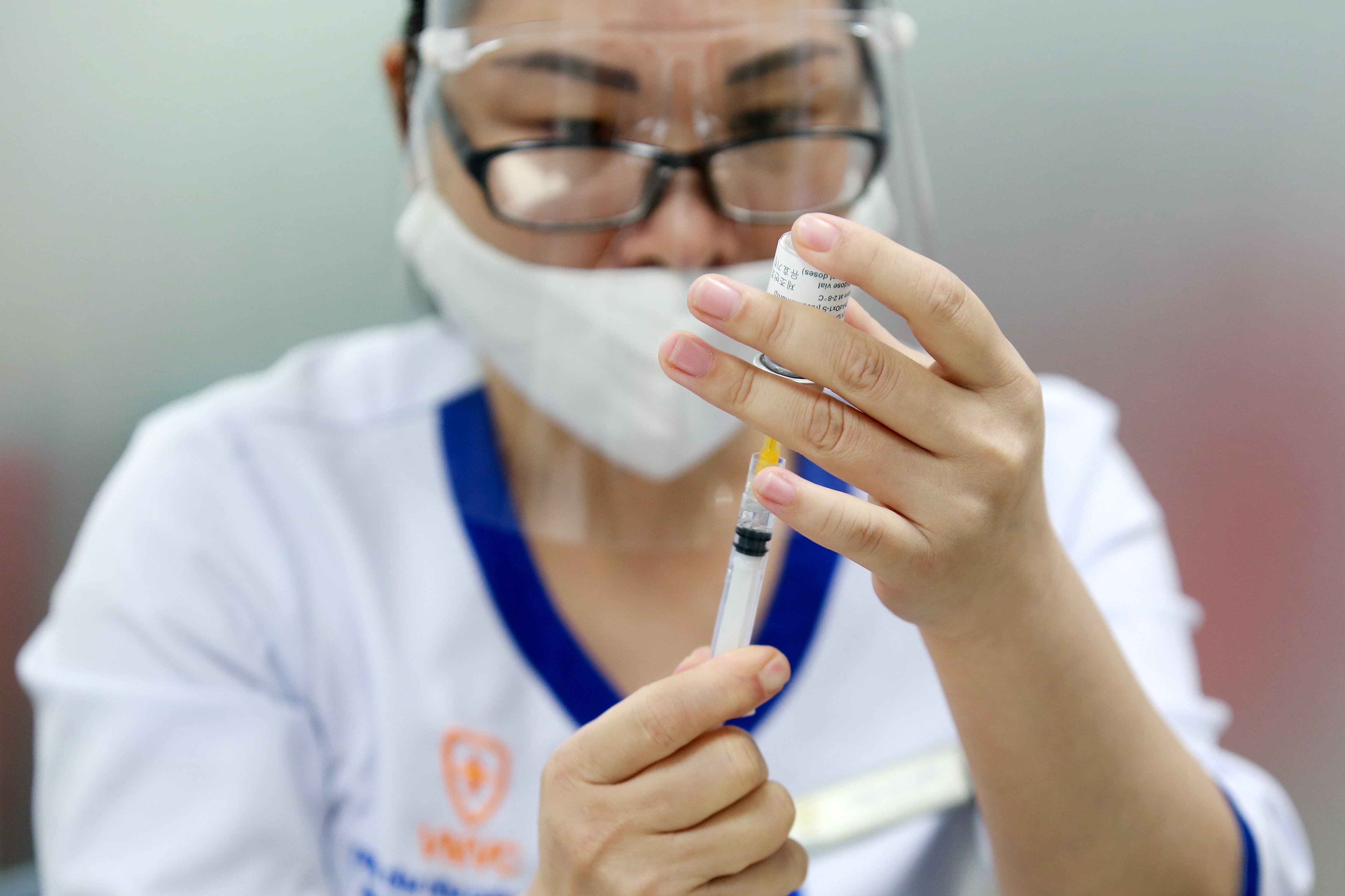A health worker prepares a shot of the AstraZeneca Covid-19 vaccine in Hanoi, Vietnam. Photo: EPA-EFE