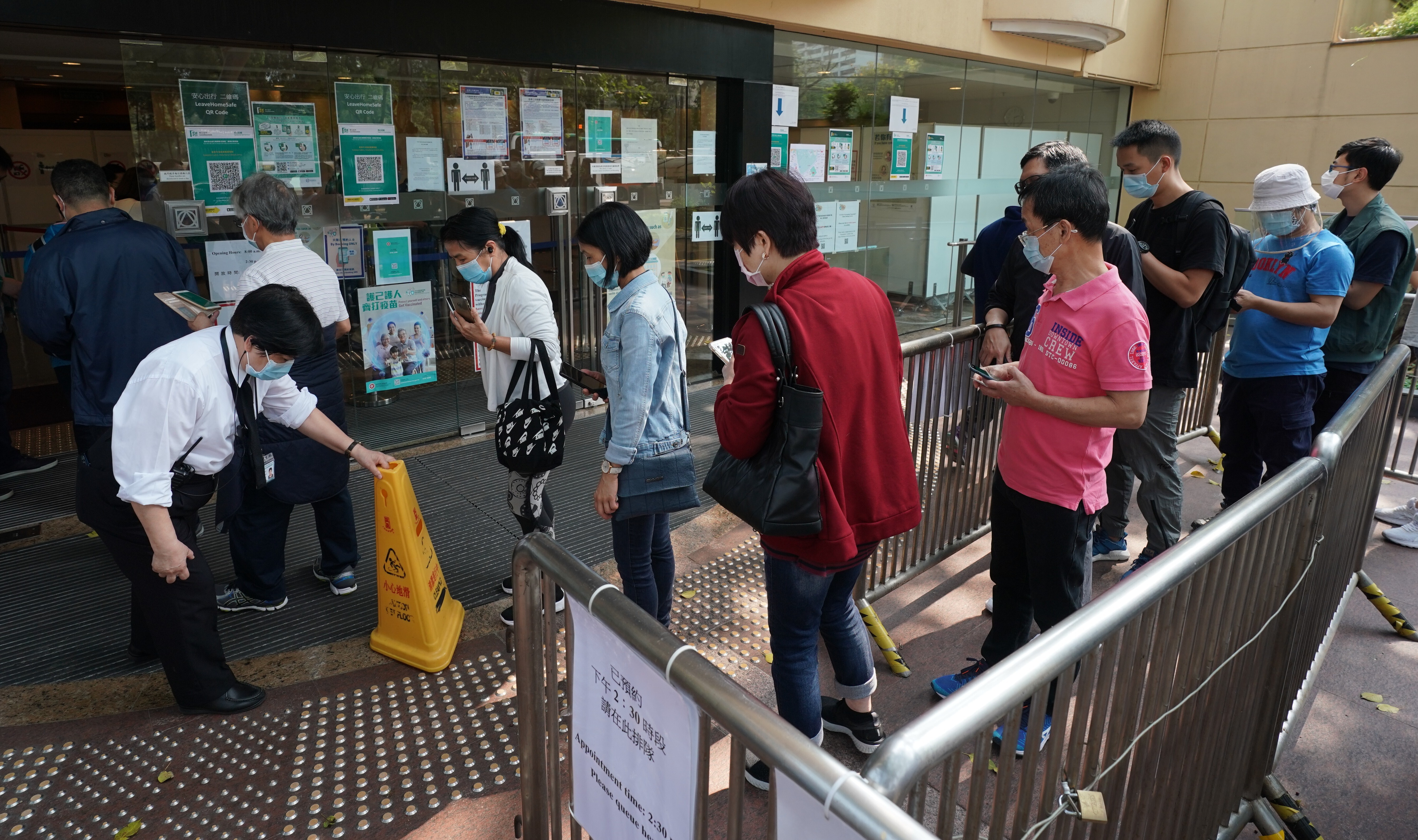 People queue for vaccination at the Community Vaccination Centre for Sinovac vaccines in Hong Kong Central Library, Causeway Bay. Photo: SCMP/Felix Wong
