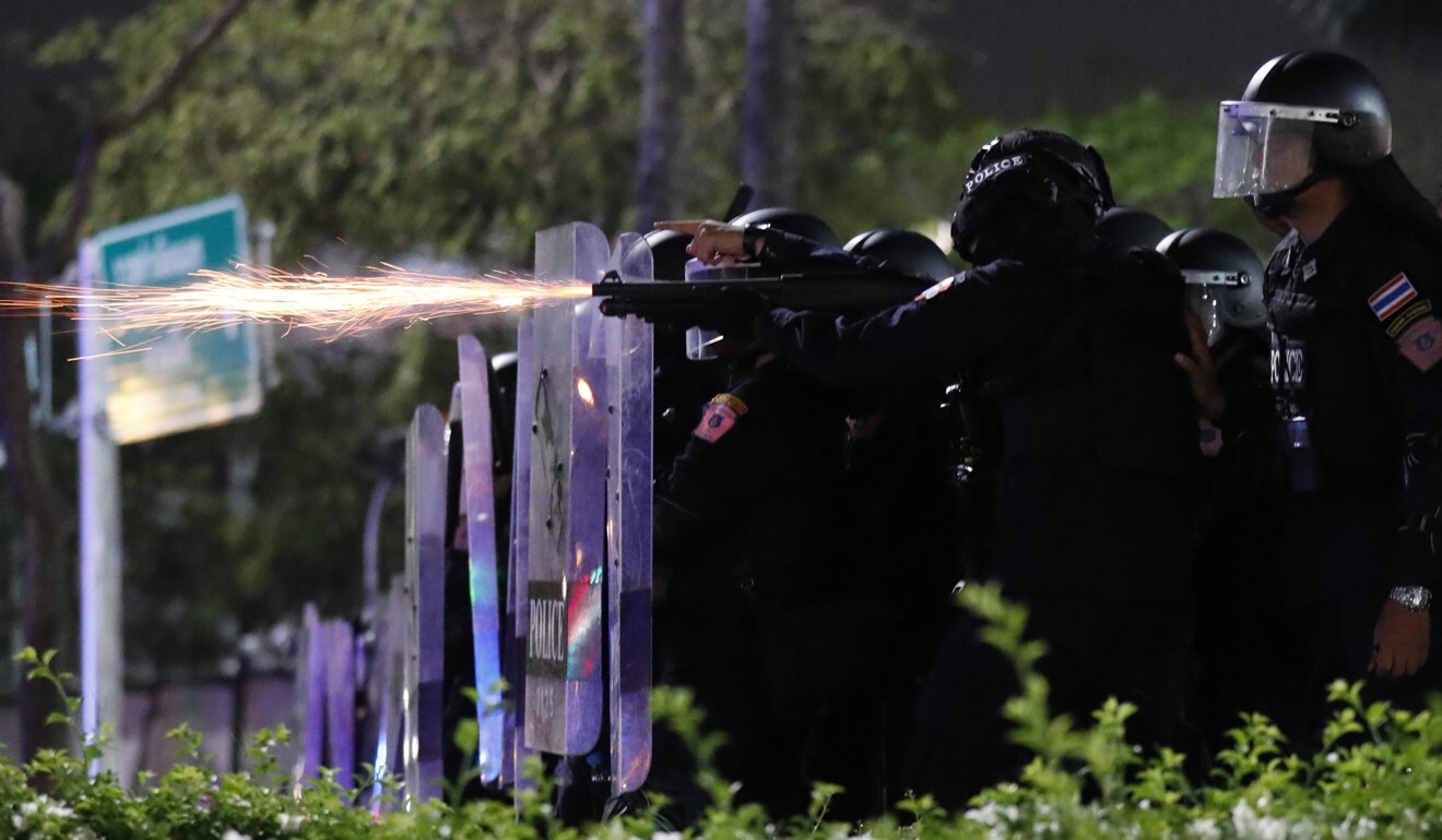 Sparks fly from the barrel of a gun used by riot police to disperse protesters in front of the Grand Palace in Bangkok on March 20, 2021. Photo: AP