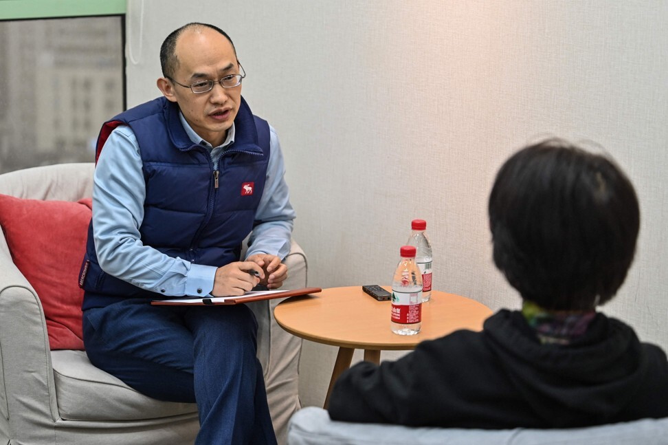 Marriage counsellor Zhu Shenyong, left, advises a client in Shanghai. Zhu has been in high demand as more Chinese couples contemplate divorce. Photo: AFP