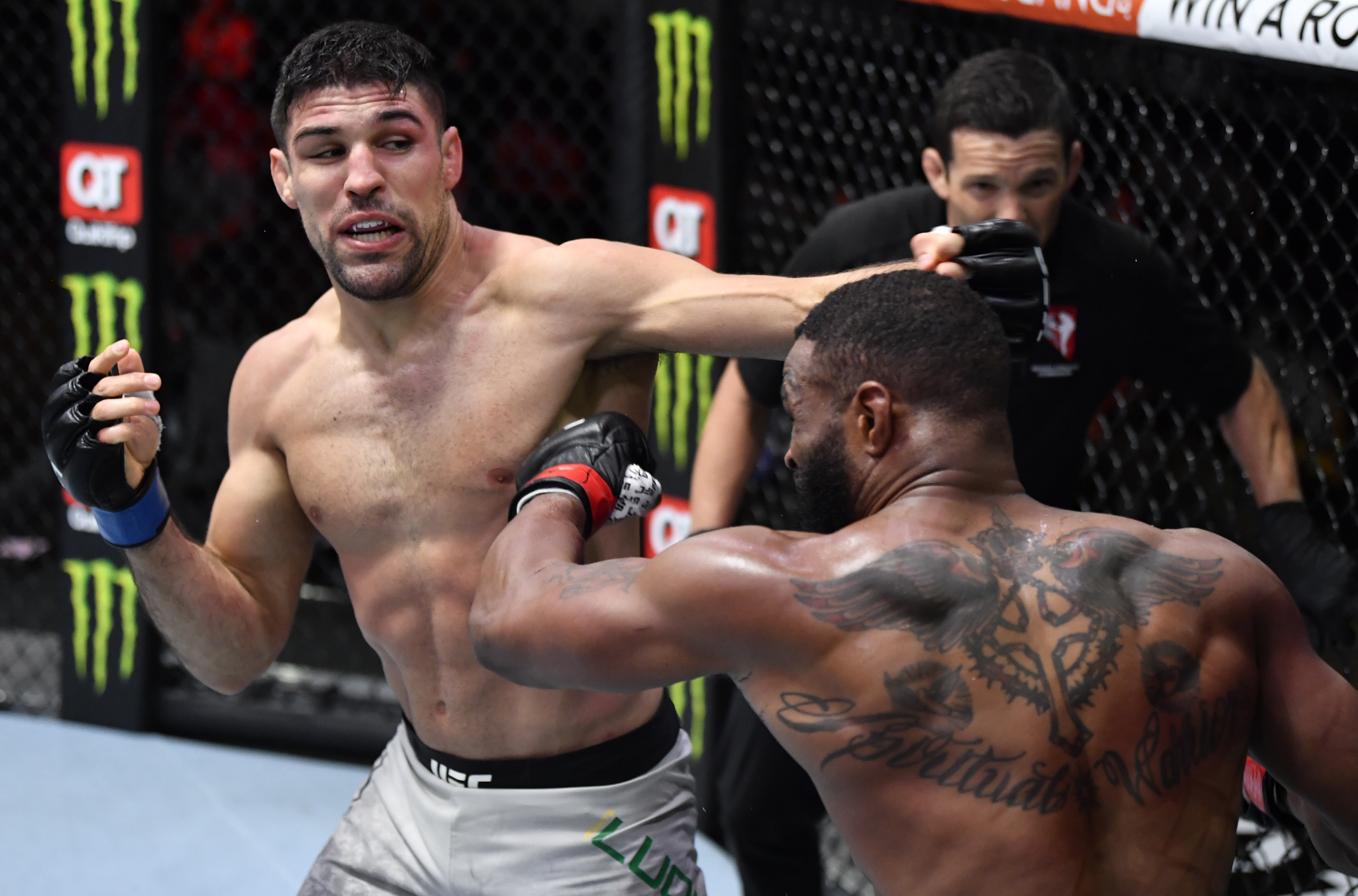 Vicente Luque punches Tyron Woodley in their welterweight fight at UFC 260. Photos: Jeff Bottari/Zuffa LLC