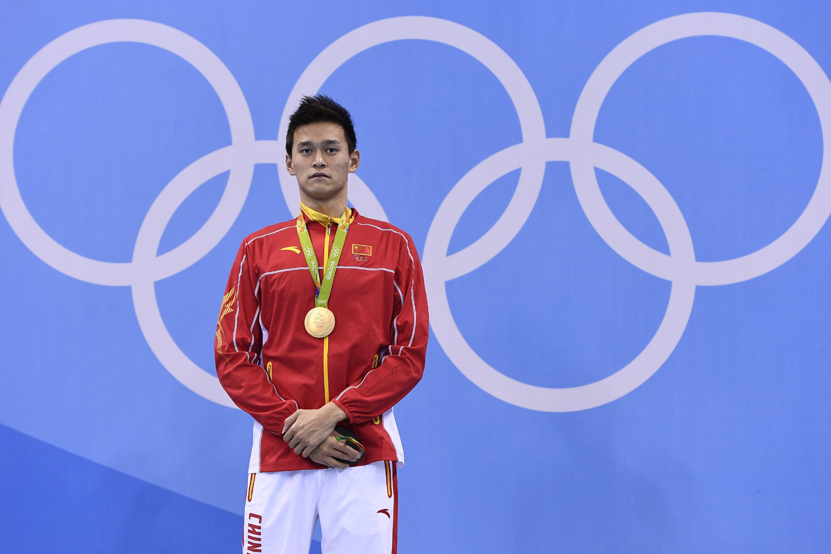 China's Sun Yang poses with his gold medal on the podium after he won the men's 200m freestyle final at the Rio 2016 Olympic Games. Photo: AFP