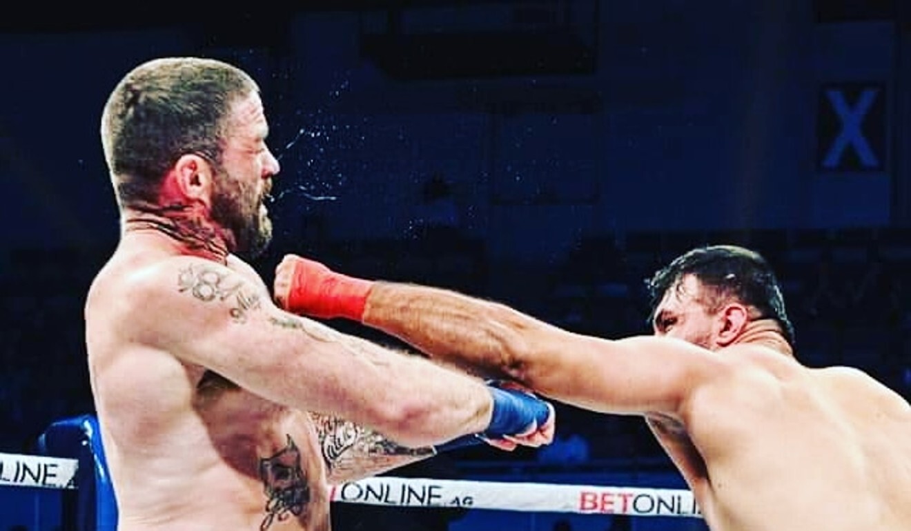 Ezatullah Kakar throws a punch against Chris Sarro in their BKFC 17 cruiserweight clash in Birmingham, Alabama.