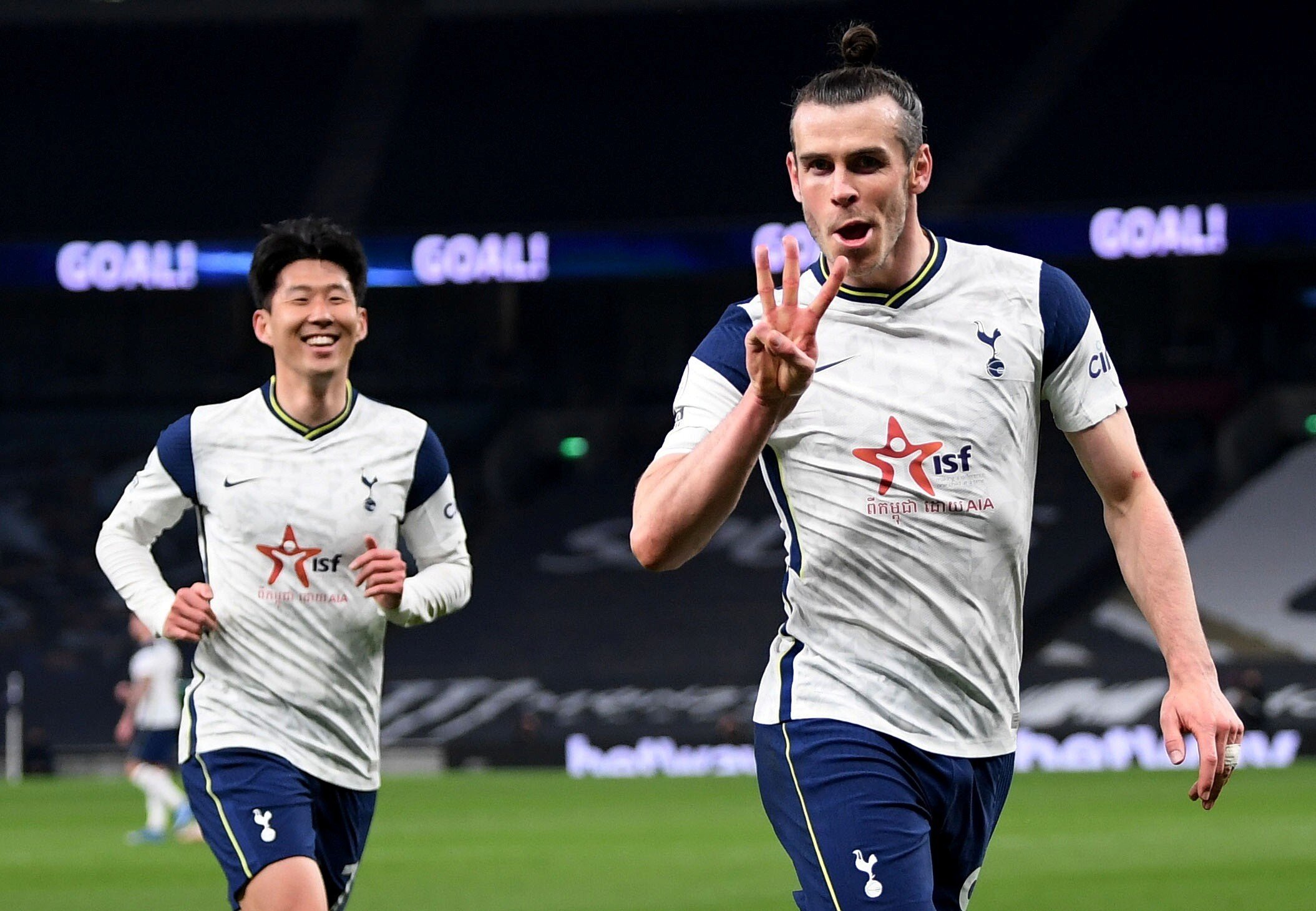 Gareth Bale celebrates scoring Tottenham Hotspur’s third goal and his hat-trick with Son Heung-min. Spurs wore the logo of Cambodian NGO Indochina Starfish Foundation on their shirts. Photo: Reuters