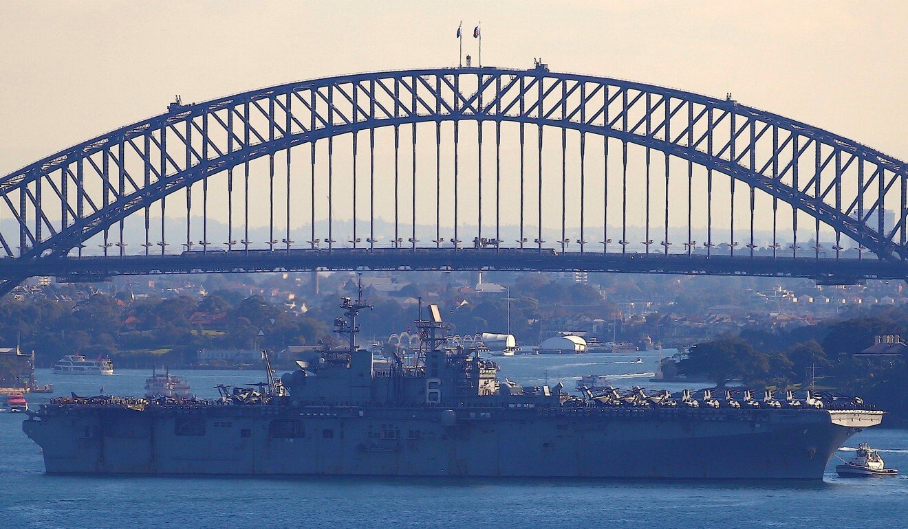 The USS Bonhomme Richard amphibious assault ship manoeuvres into port in front of the Sydney Harbour Bridge in Australia. Photo: Reuters
