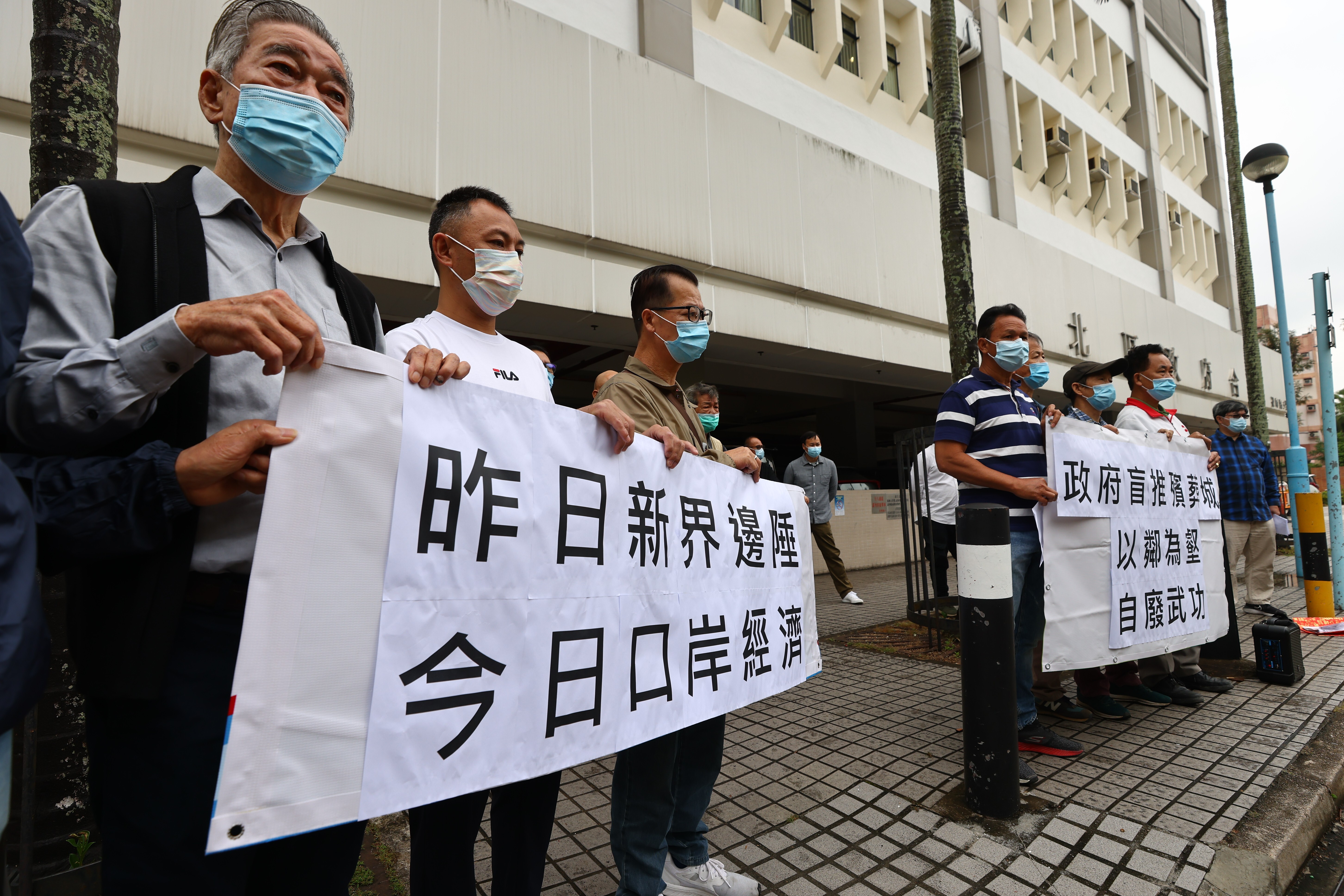 Members of the Ta Kwu Ling District Rural Committee object to a government move to set up a construction site office and storage for the Sandy Ridge “super funeral city”, at the North District government office in Fanling, on April 9. Photo: Dickson Lee