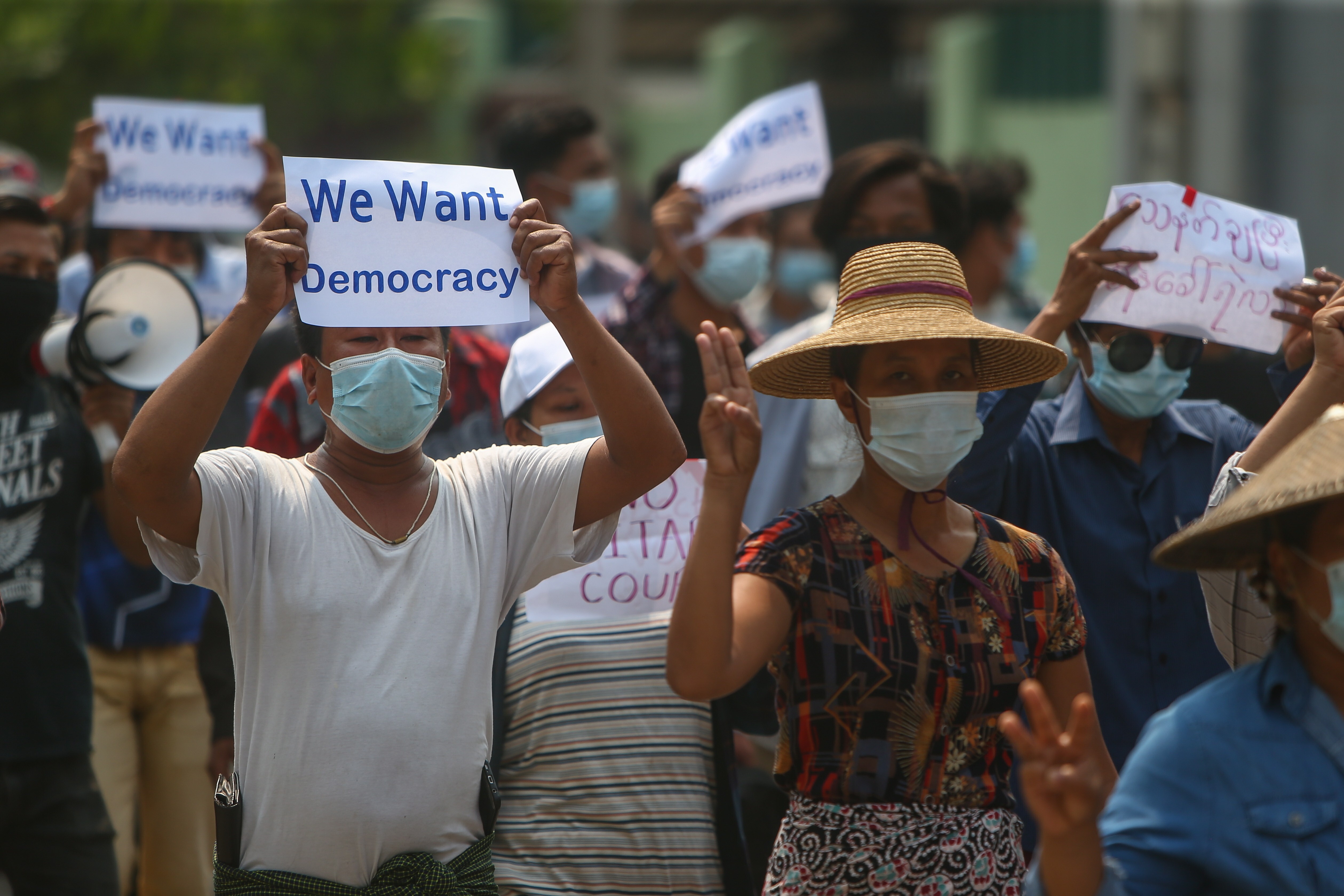 Demonstrators flash the three-finger salute and carry placards calling for democracy during an anti-military-coup protest in Mandalay, Myanmar, on April 26. Photo: EPA-EFE